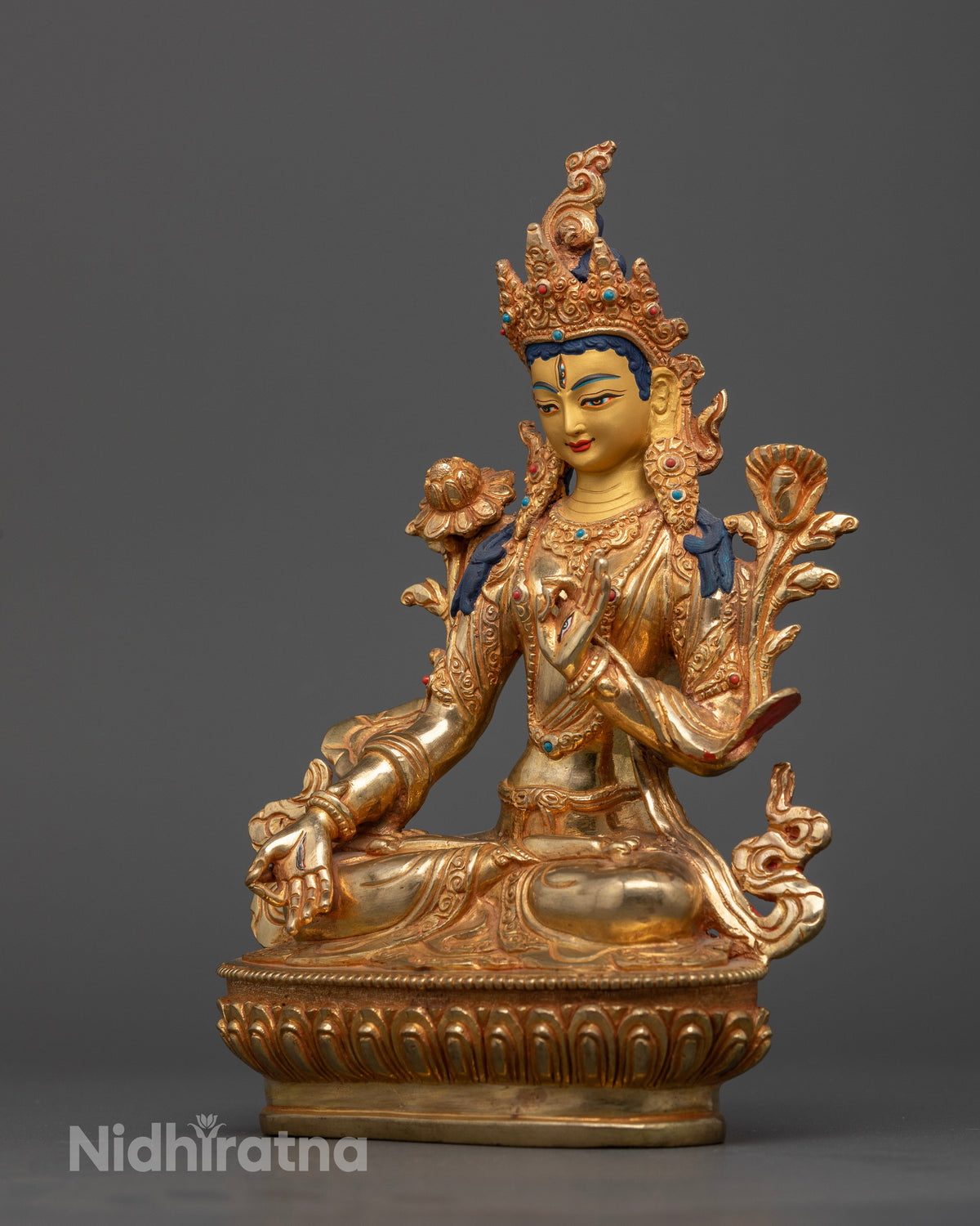 White Tara statue seated on hand carved lotus pedestal.