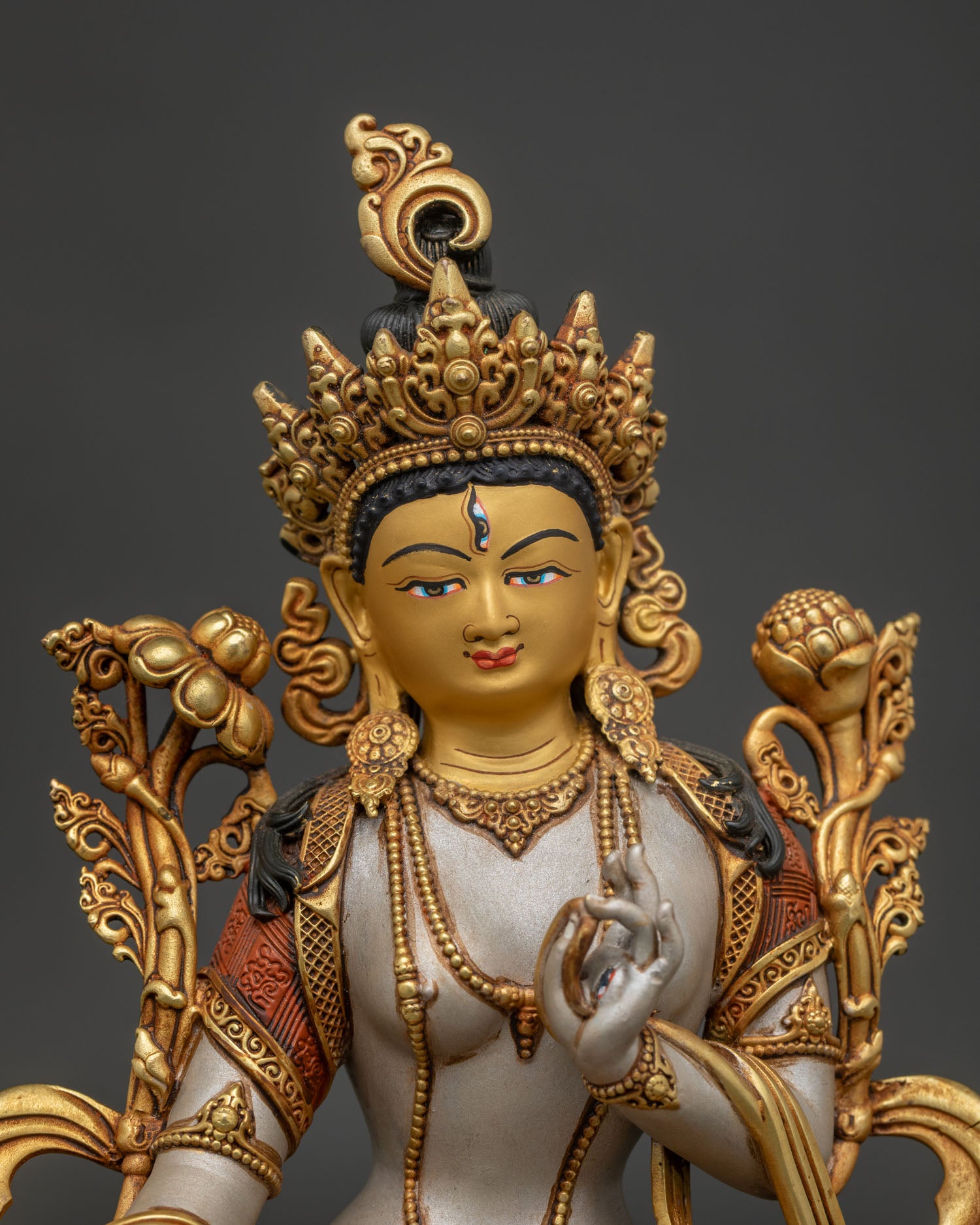 White Tara Statue shown from the right side with intricate robes, jeweled crown and detailed copper craftsmanship