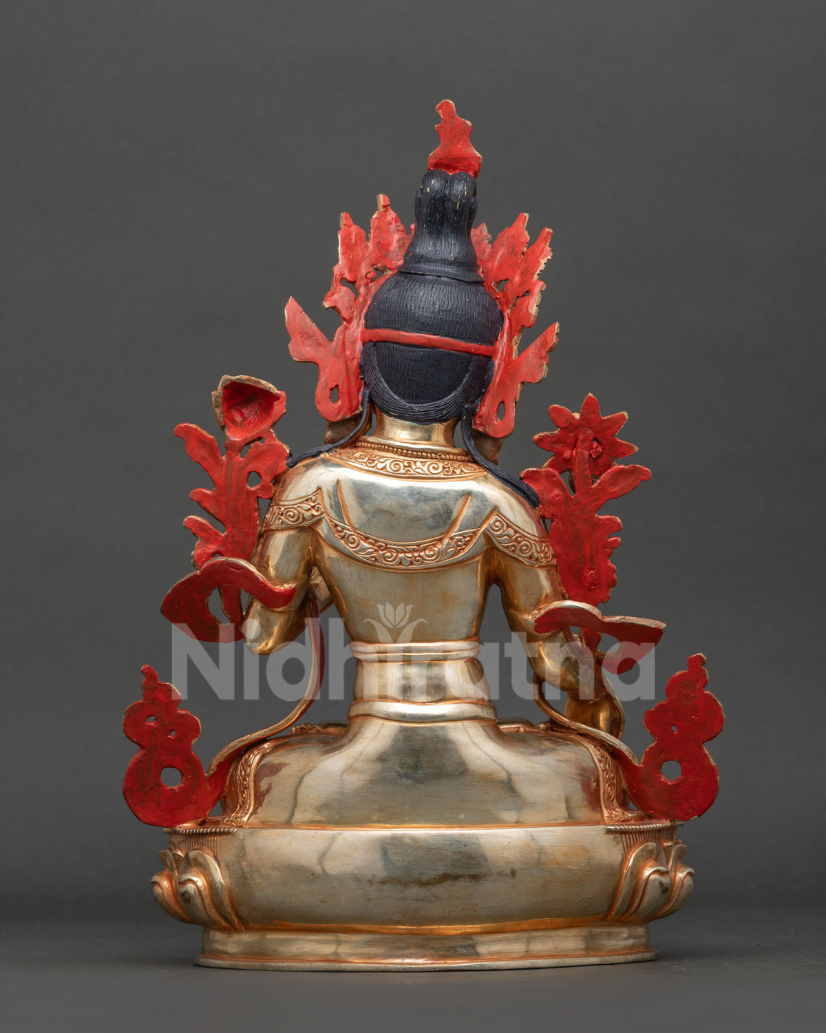 White Tara statue with gold gilded copper robes lotus pedestal and ornate hand chased floral decorations.