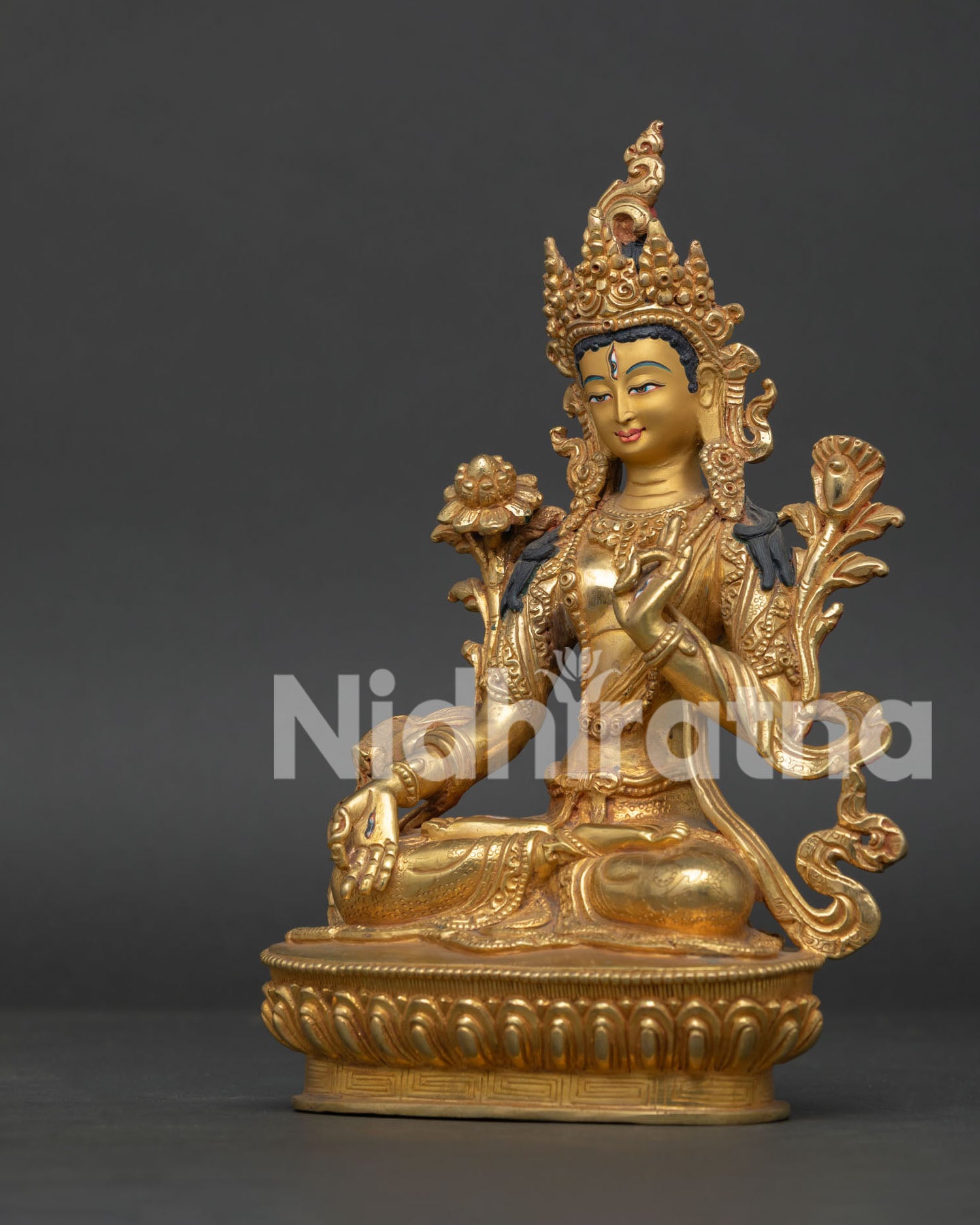 White Tara statue with seven eyes and gold gilded copper finish.