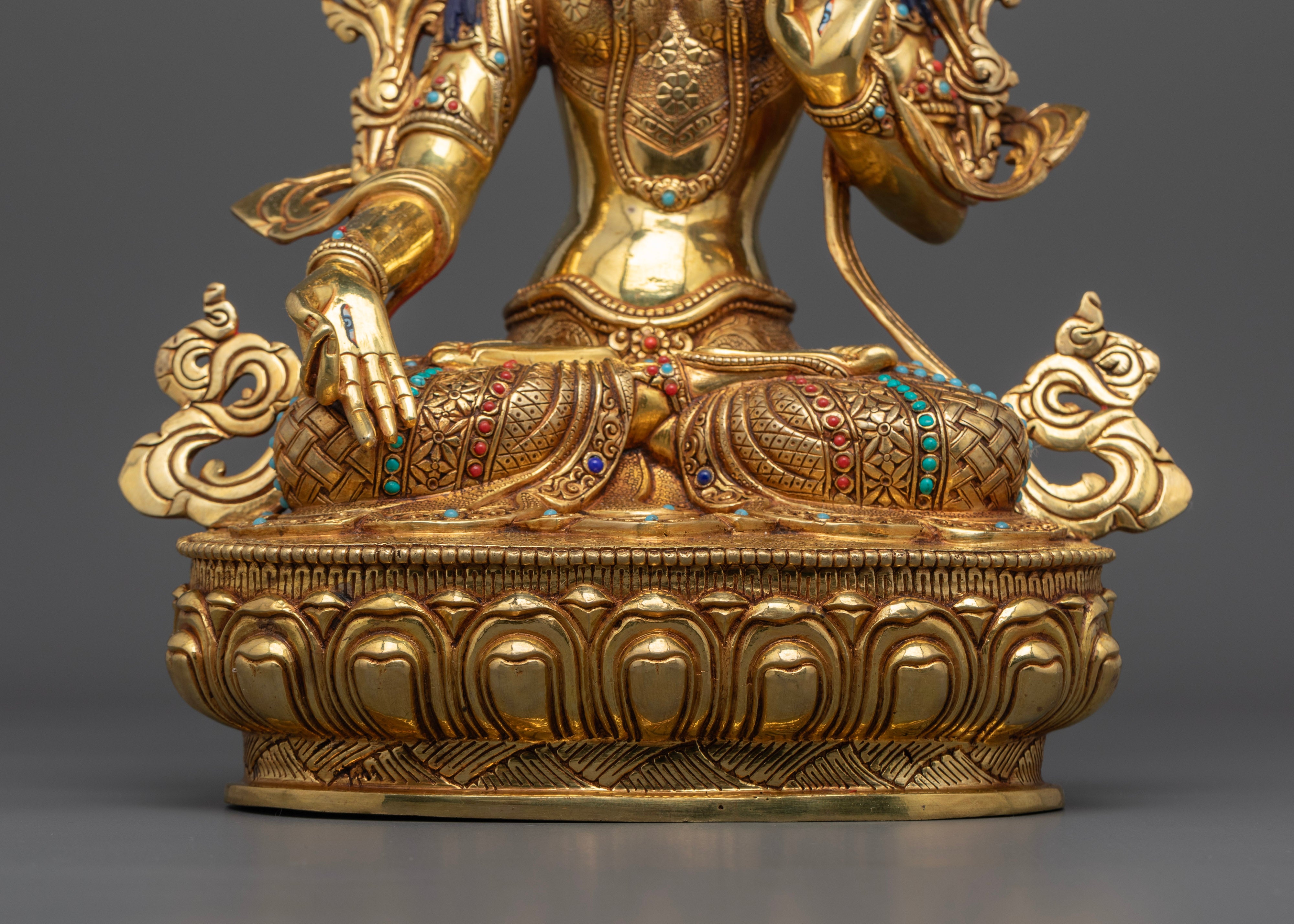 golden white tara statue sitting on top of moon disc on a lotus seat