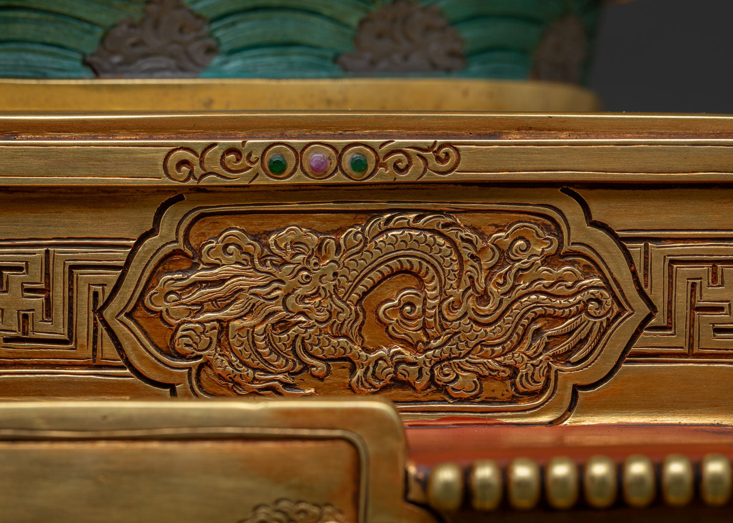 Wide dragon relief panel hand-chased on Dzambhala Statue throne tier