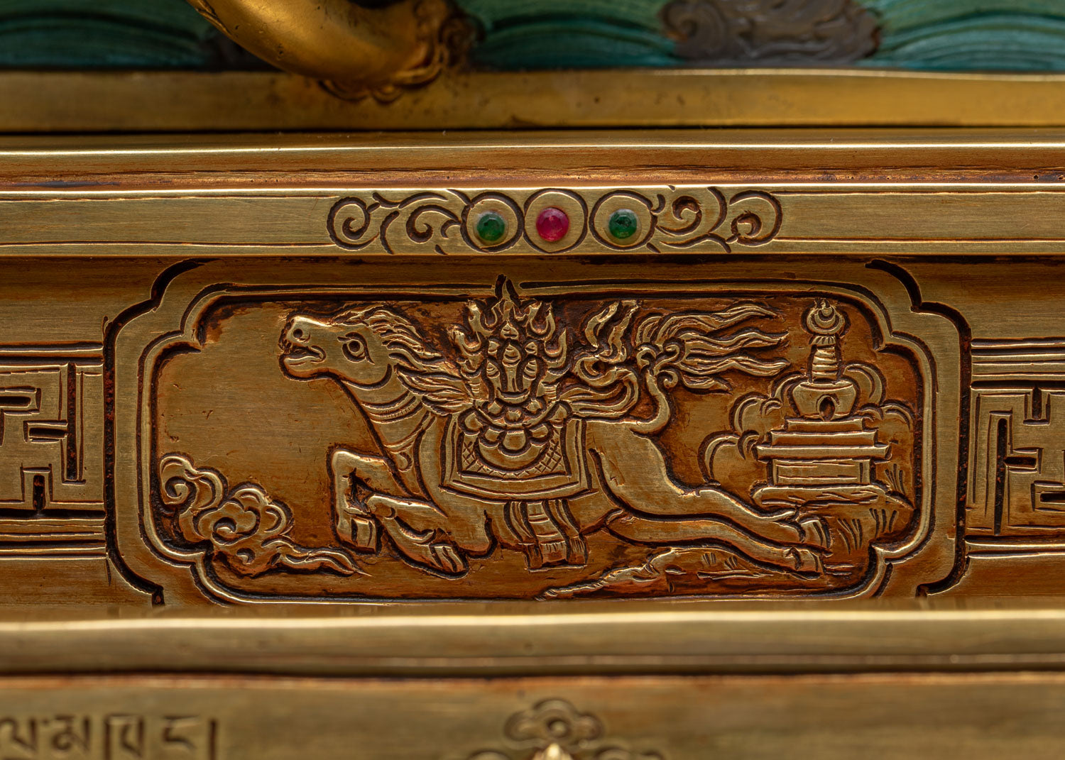 Wind horse Lungta relief carved into Dzambhala Statue's throne tier
