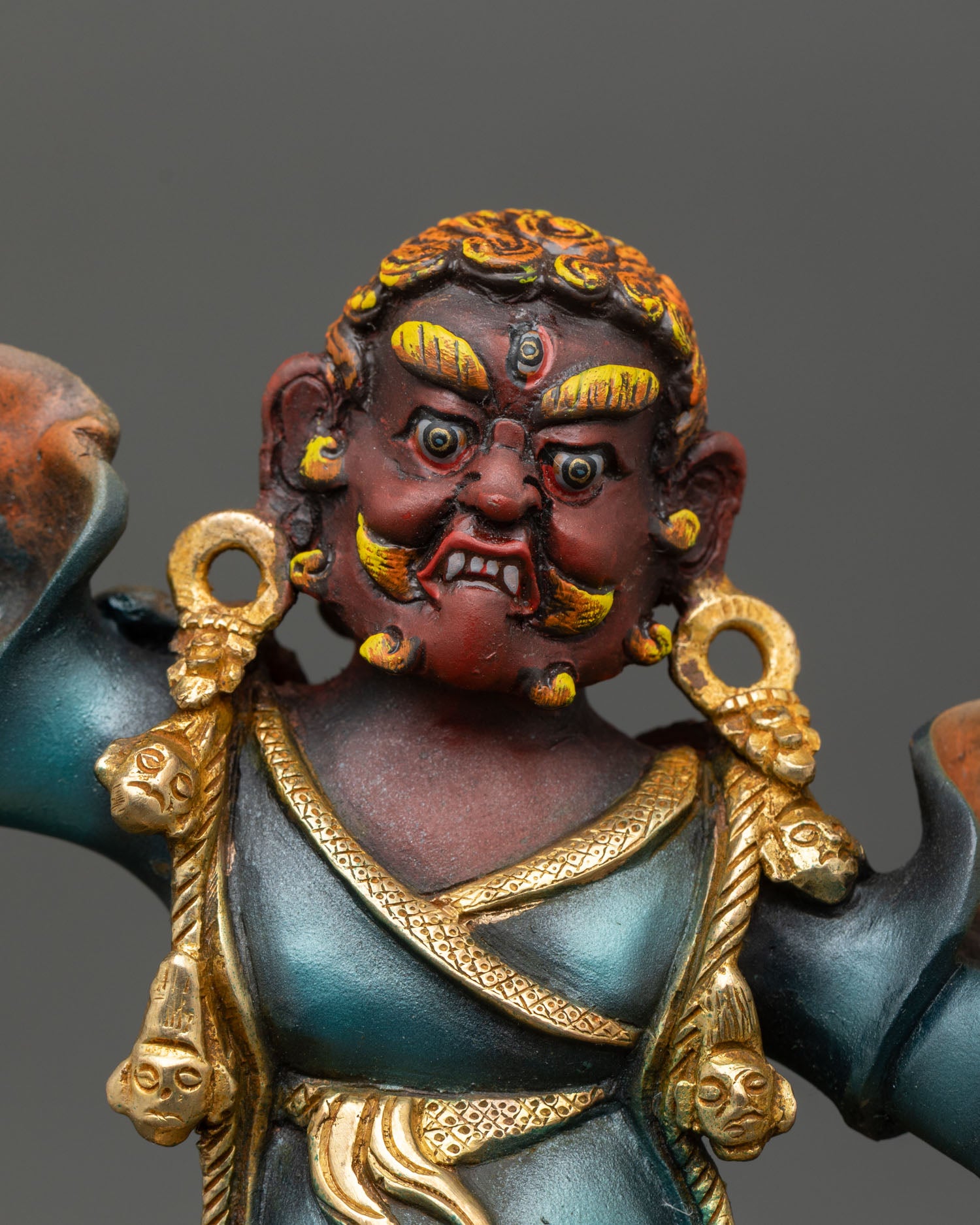 Close up of wrathful Dorje Drolo with three eyes fanged expression and flaming aureole