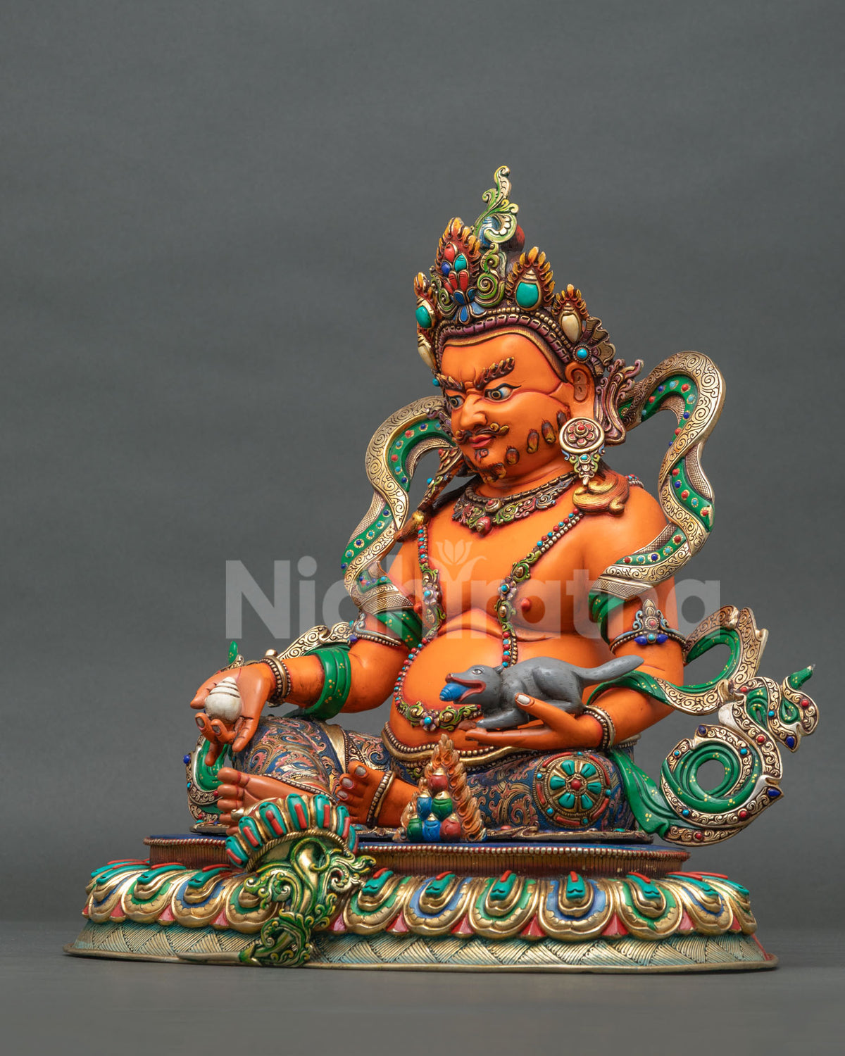 Yellow Dzambhala statue holding a citron fruit and jewel-spitting mongoose, symbolizing wealth, abundance, and prosperity.