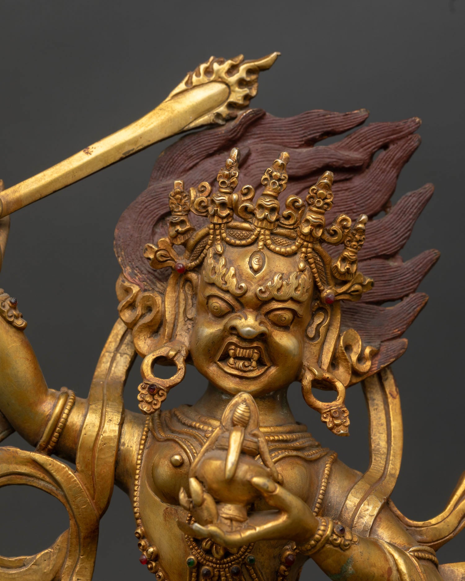 Yeshe Walmo statue, close-up detail, flaming thunderbolt sword, vase of long life nectar, Tibetan Buddhist deity art