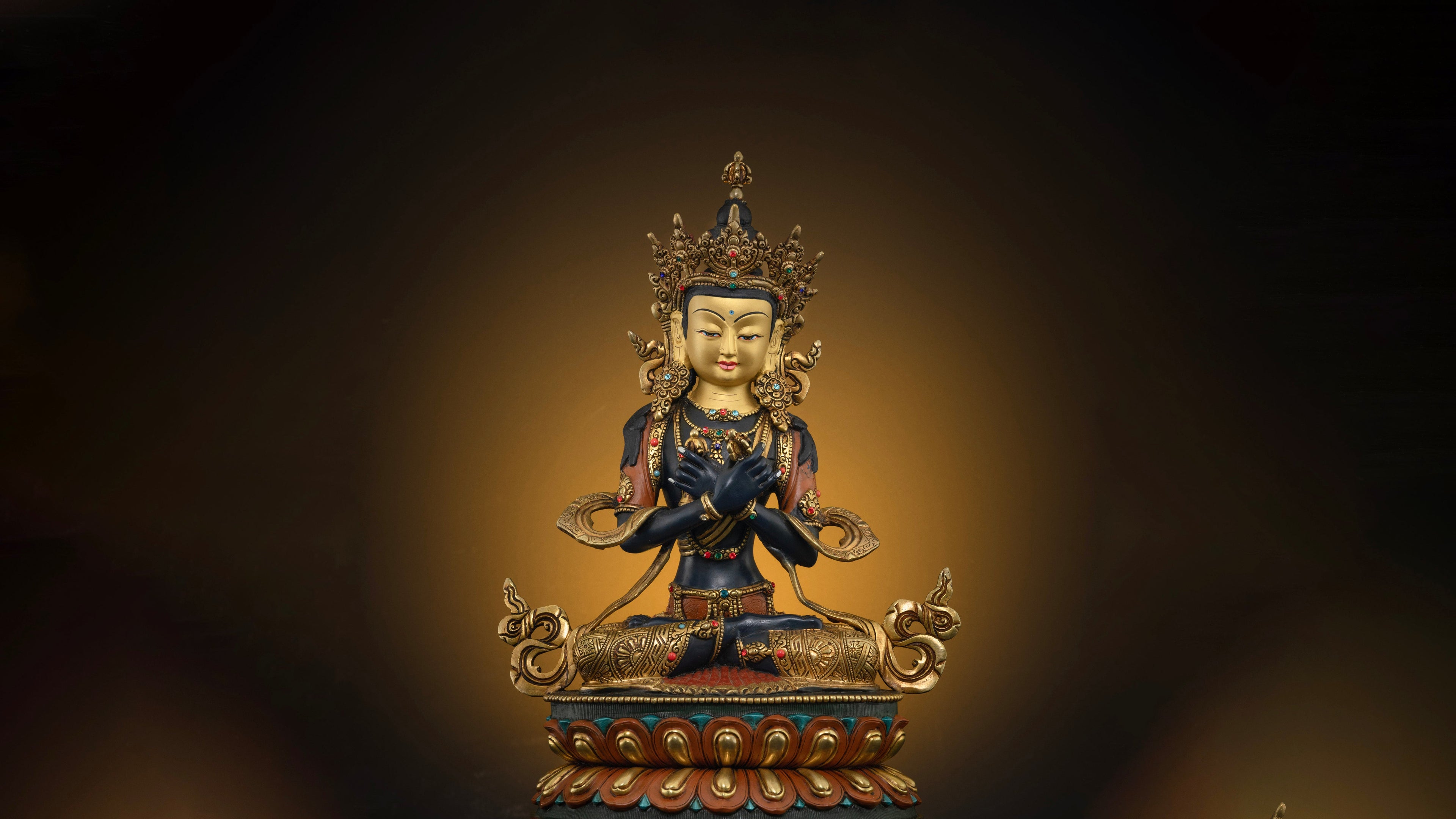 golden vajradhara statue with embellishments and other colors