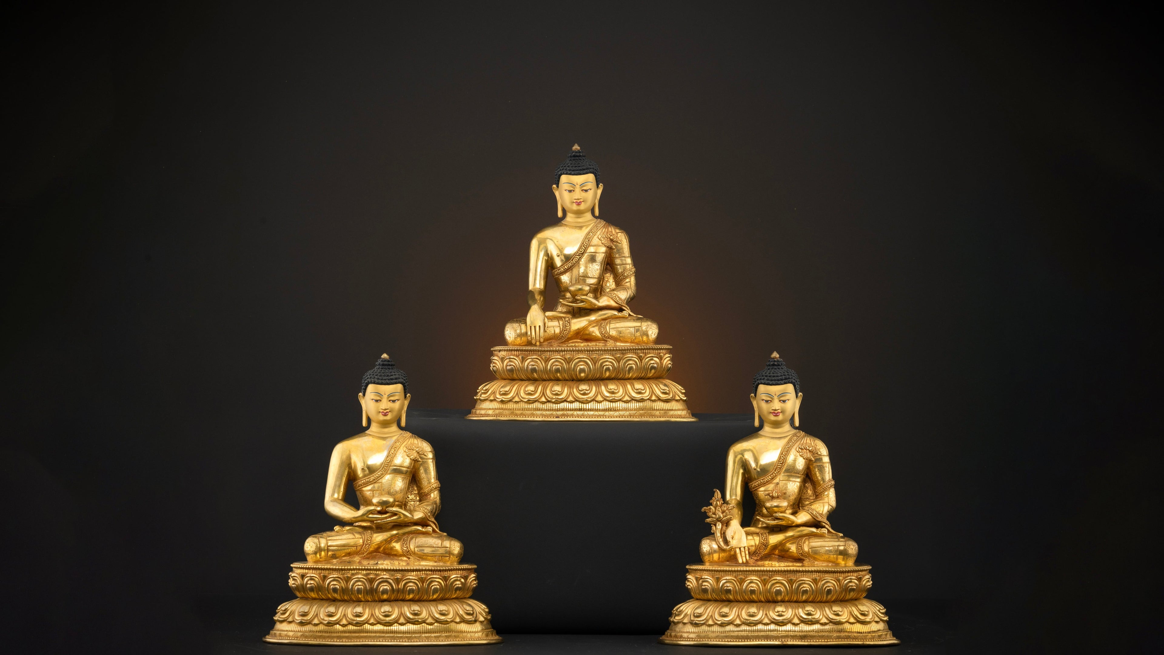 three golden buddha statues- shakyamuni buddha, amitabha buddha and medicine buddha