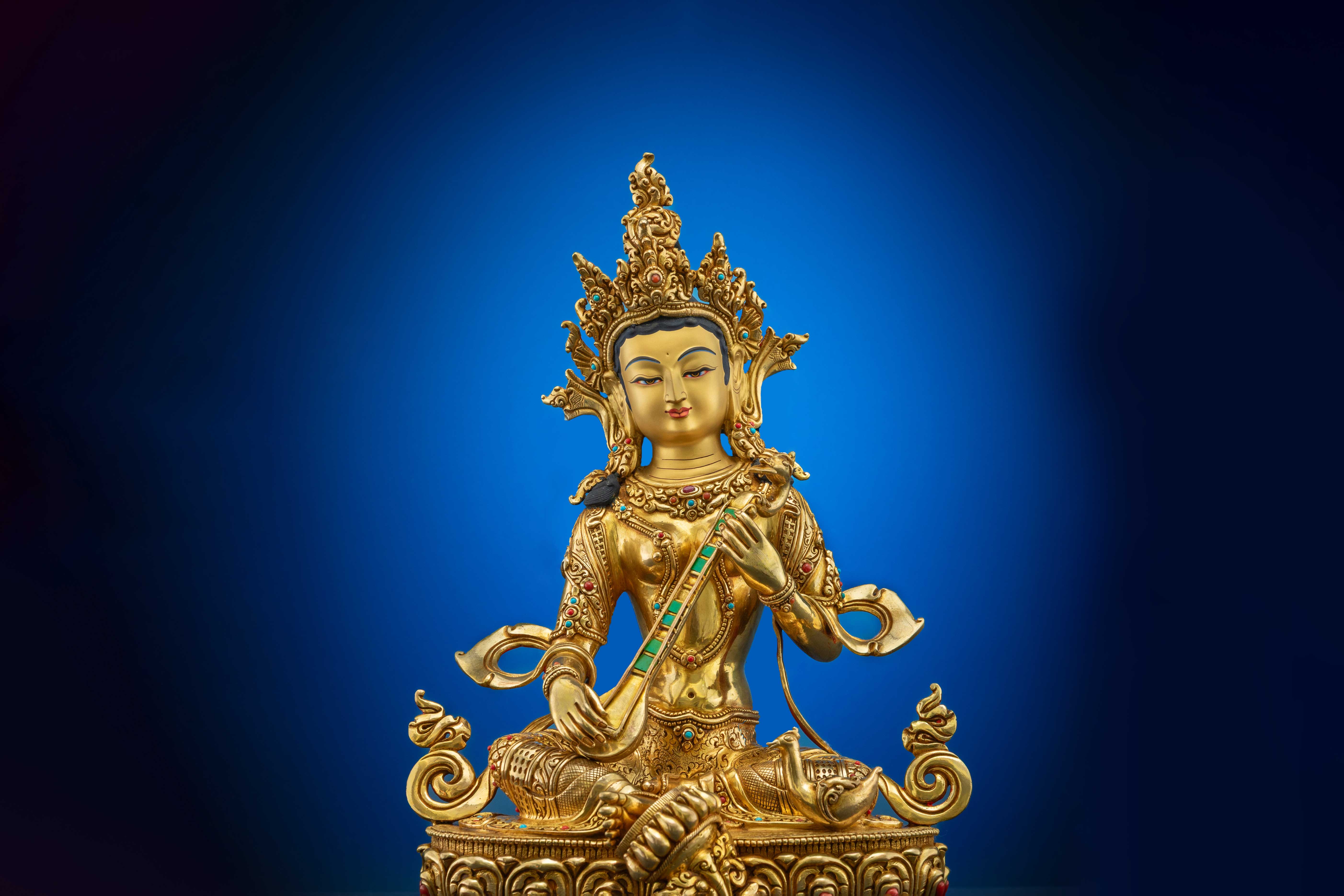 dark brown oxidized copper statue of saraswati with pure gold plated face and silver accents