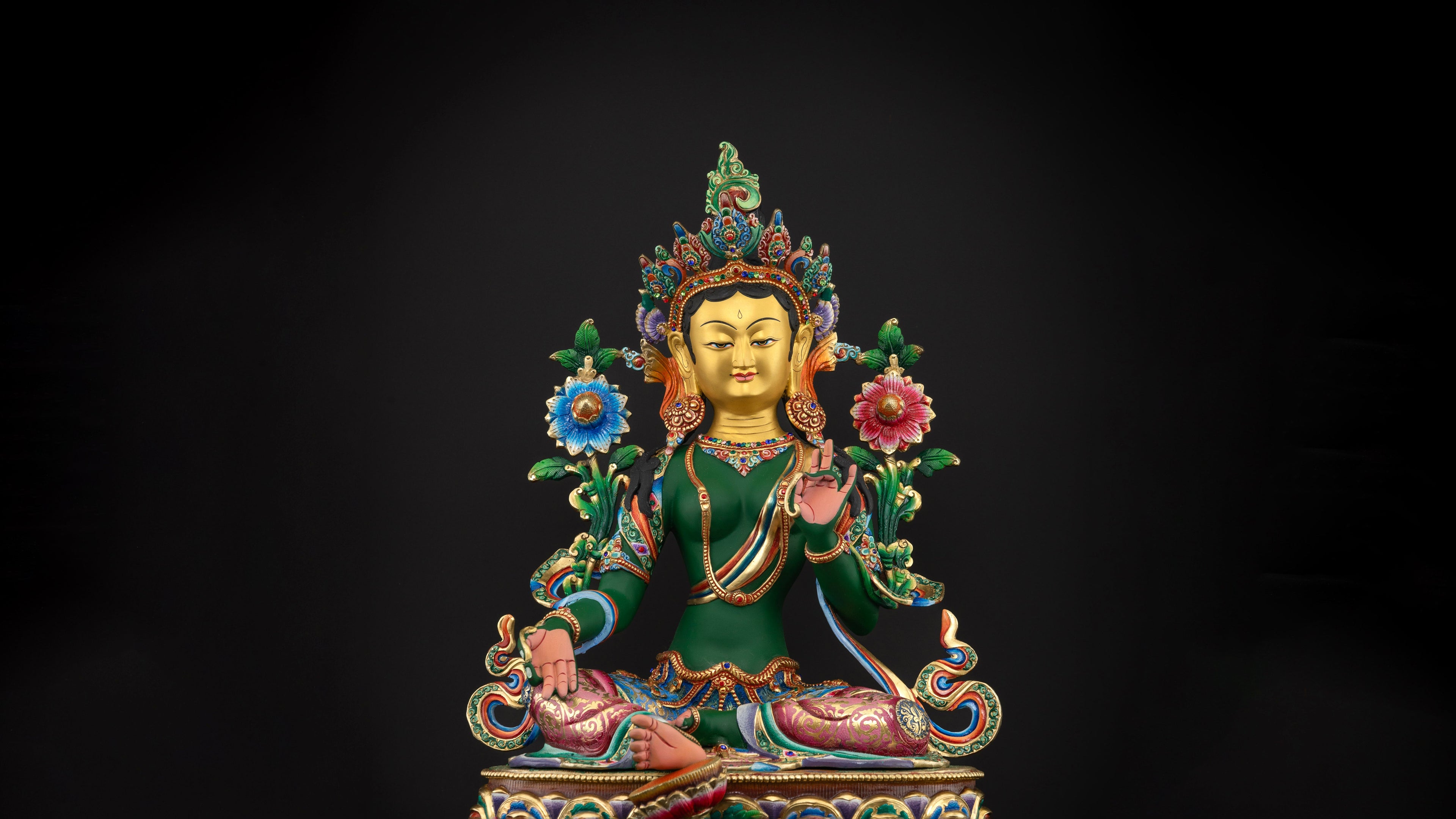 vibrantly colored green tara statue with pure gold plated face and dark green skin with other colors to add accents