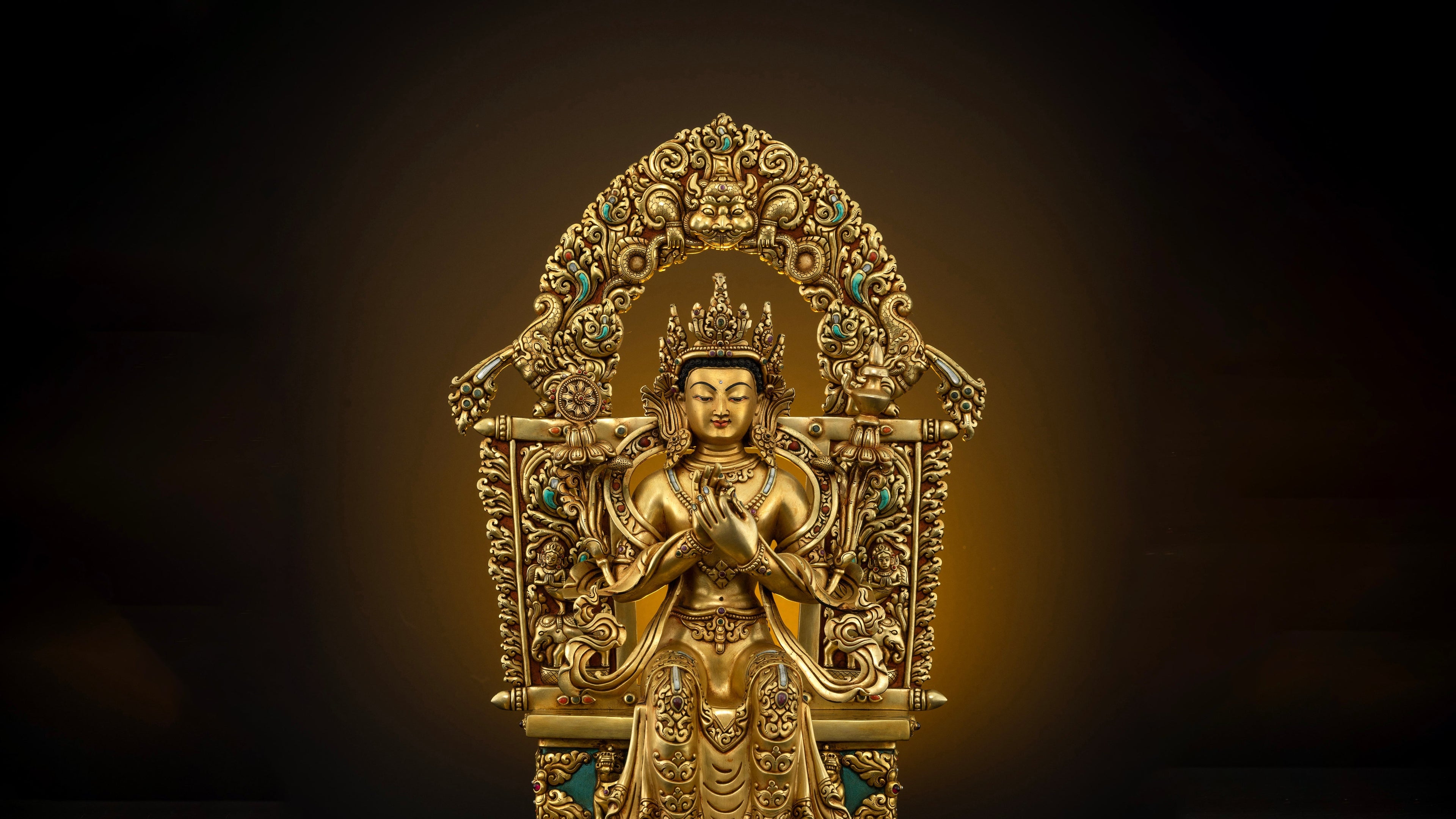 finely detailed golden Maitreya Buddha statue sitting graciously on his throne with his hands forming Dharmachakra Mudra