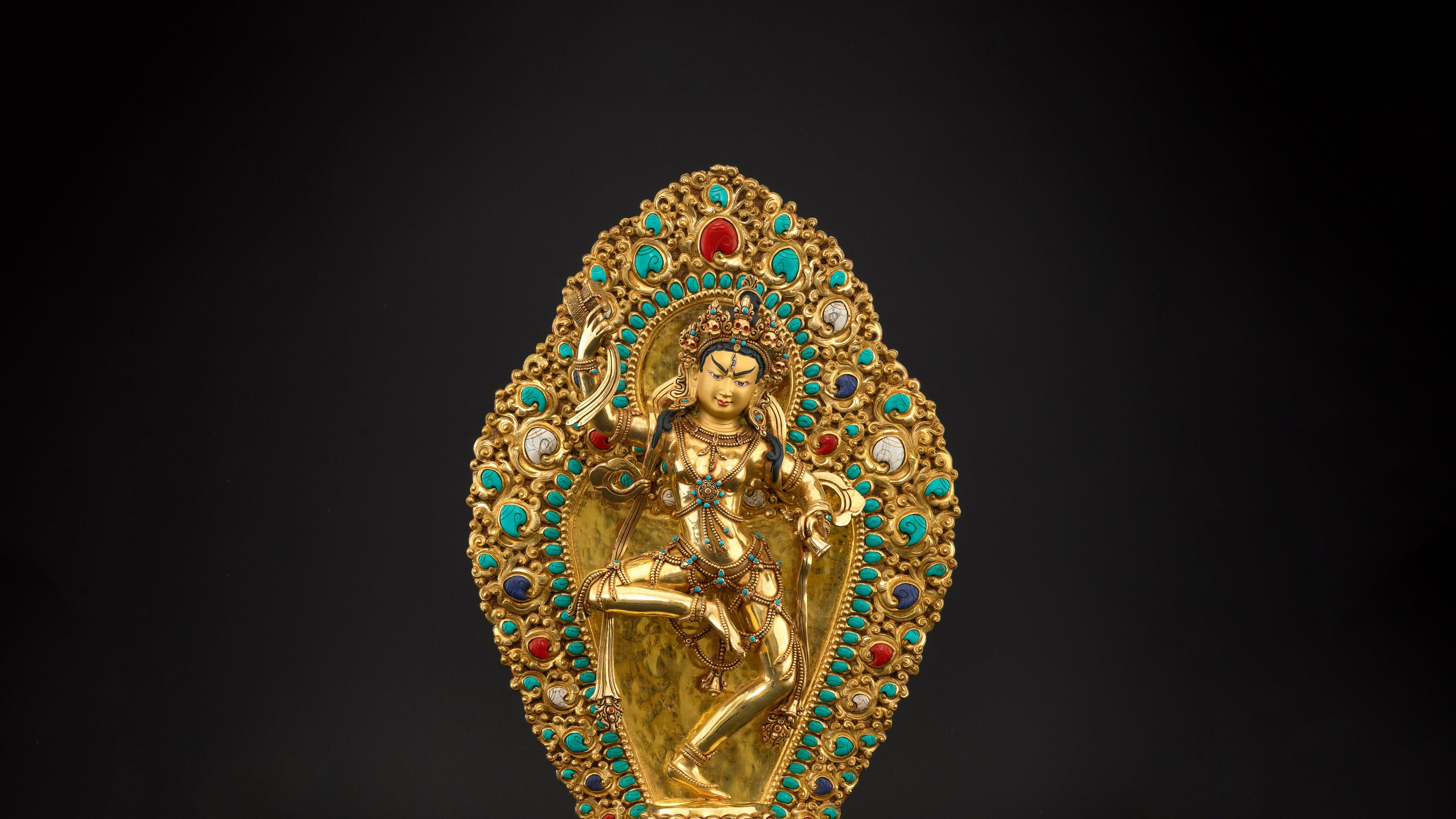 gold plated Machig Labdron statue adorned with red, turquoise and blue gemstones