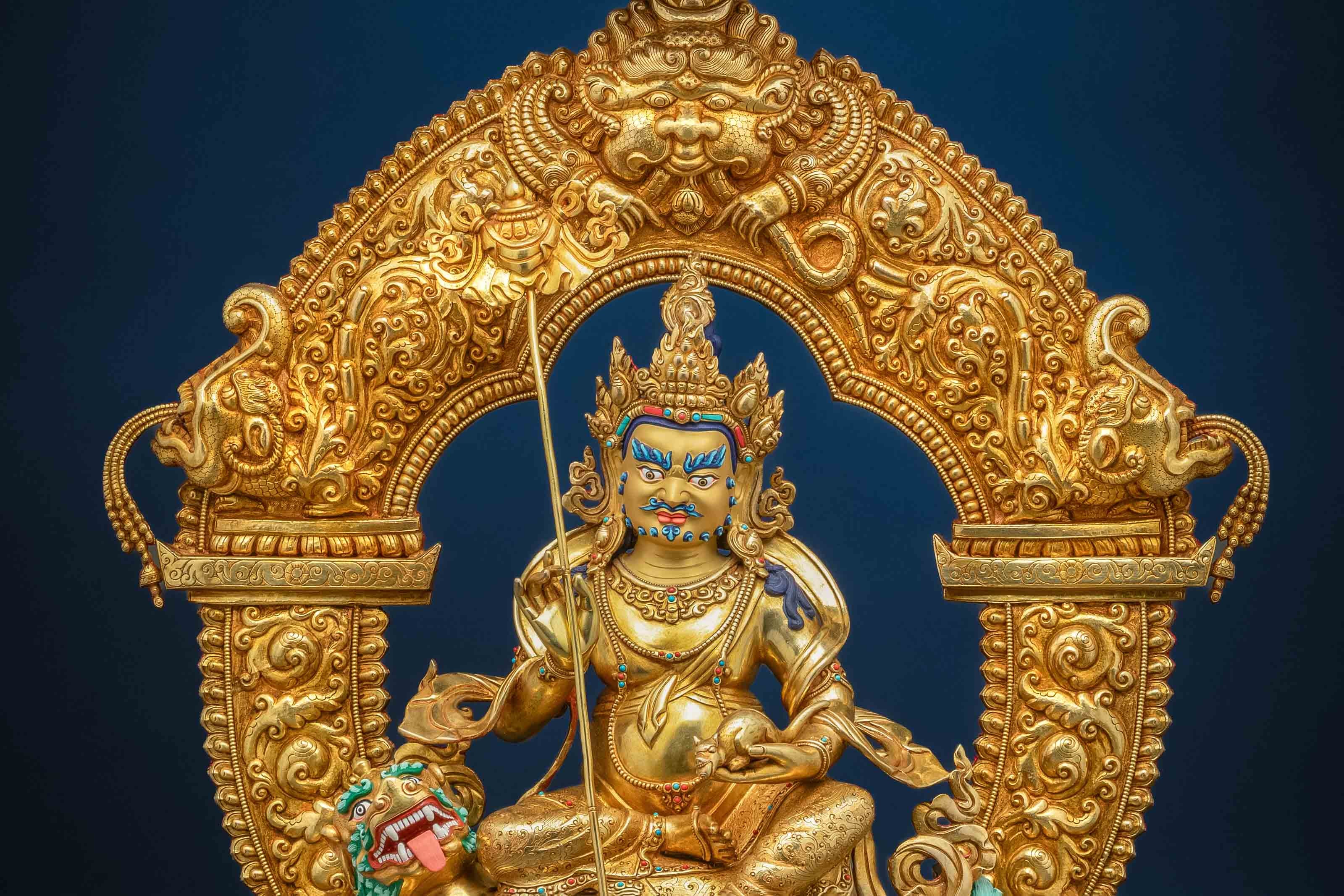 golden namtoshe statue with vibrantly colored accents in red, orange and blue