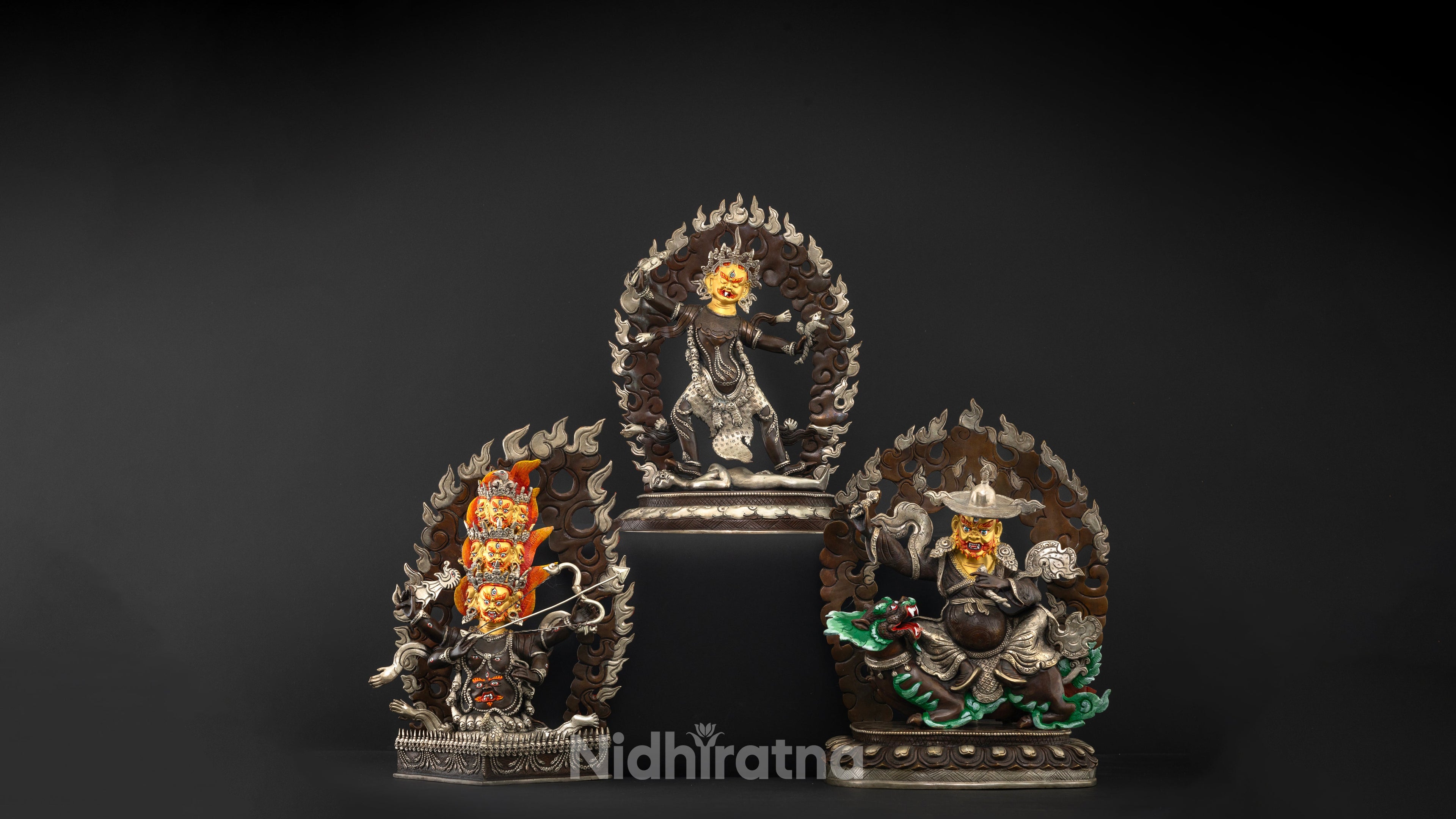 three statues in front of a black backdrop, which are the parts of Rahula set statue collection