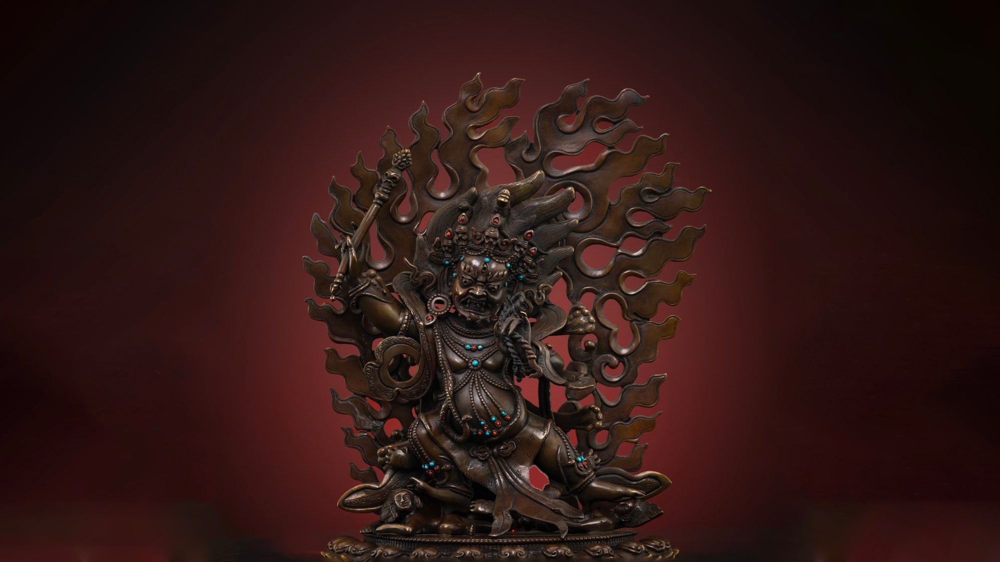 Dark brown colored copper statue of Hayagriva with intricate carvings and a fierce pose