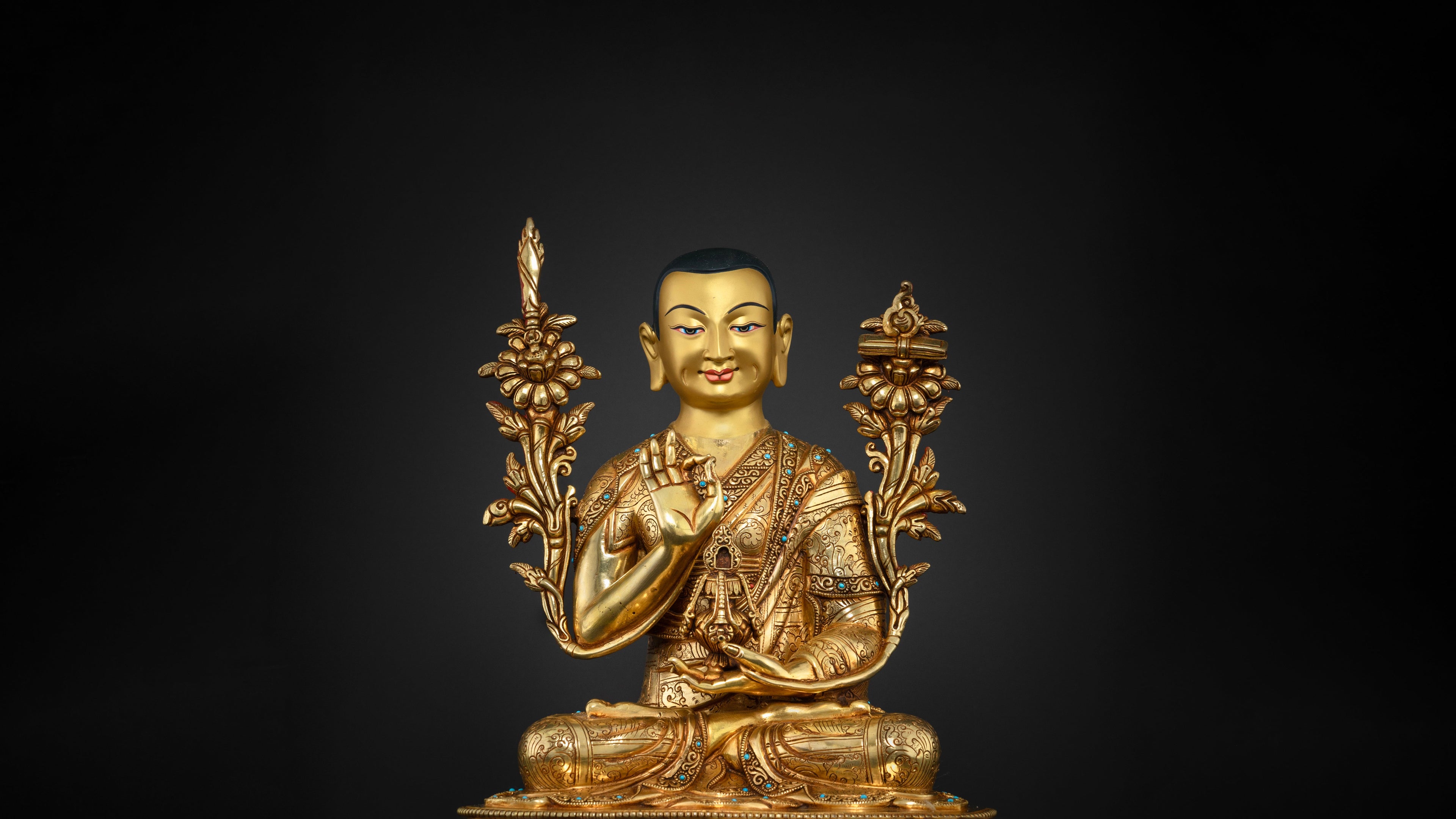 golden Tsogkhapa statue with intricate carvings and embedded gemstones