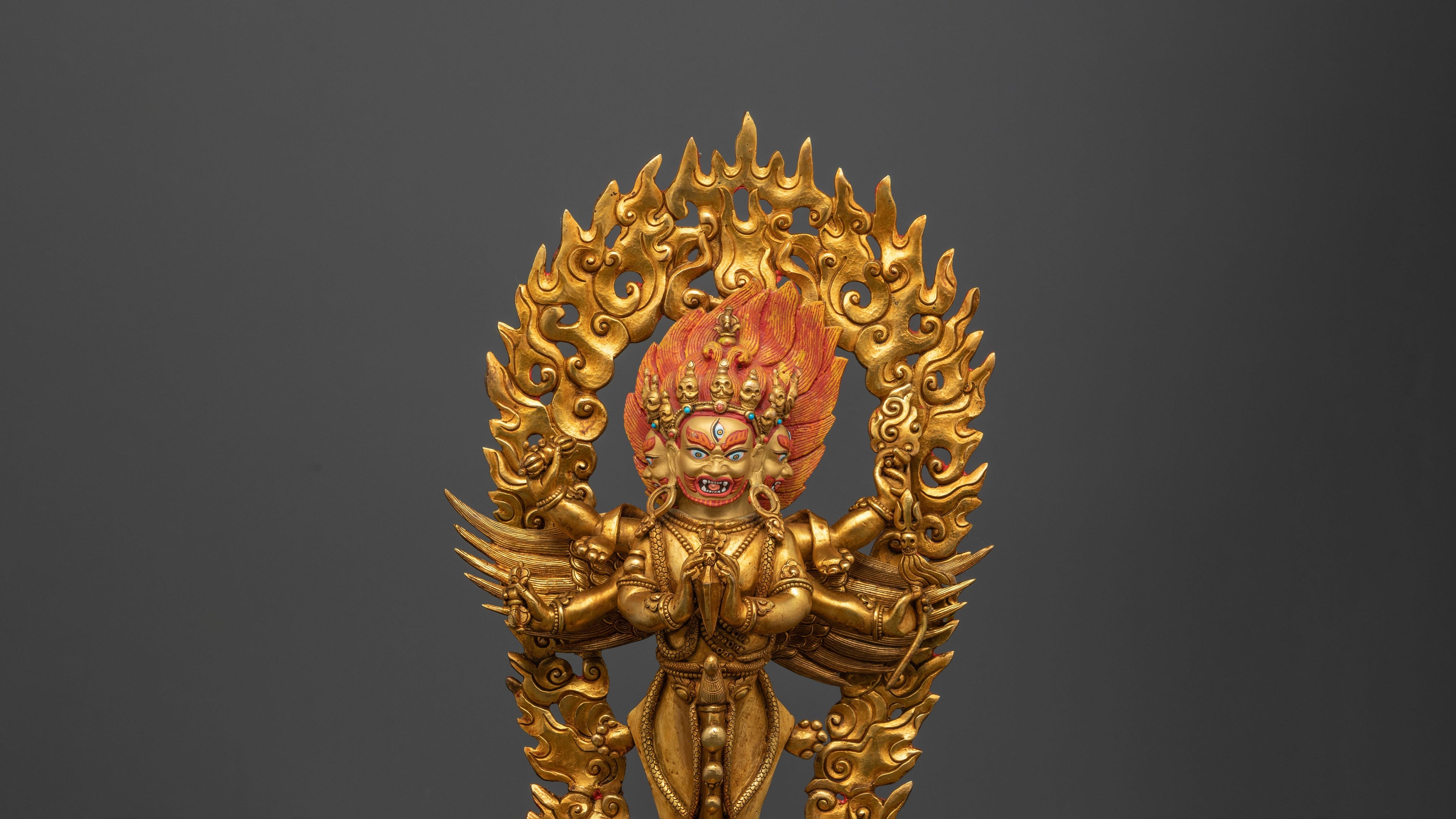 golden vajrakilaya statue with a fierce look and fires in the back of her