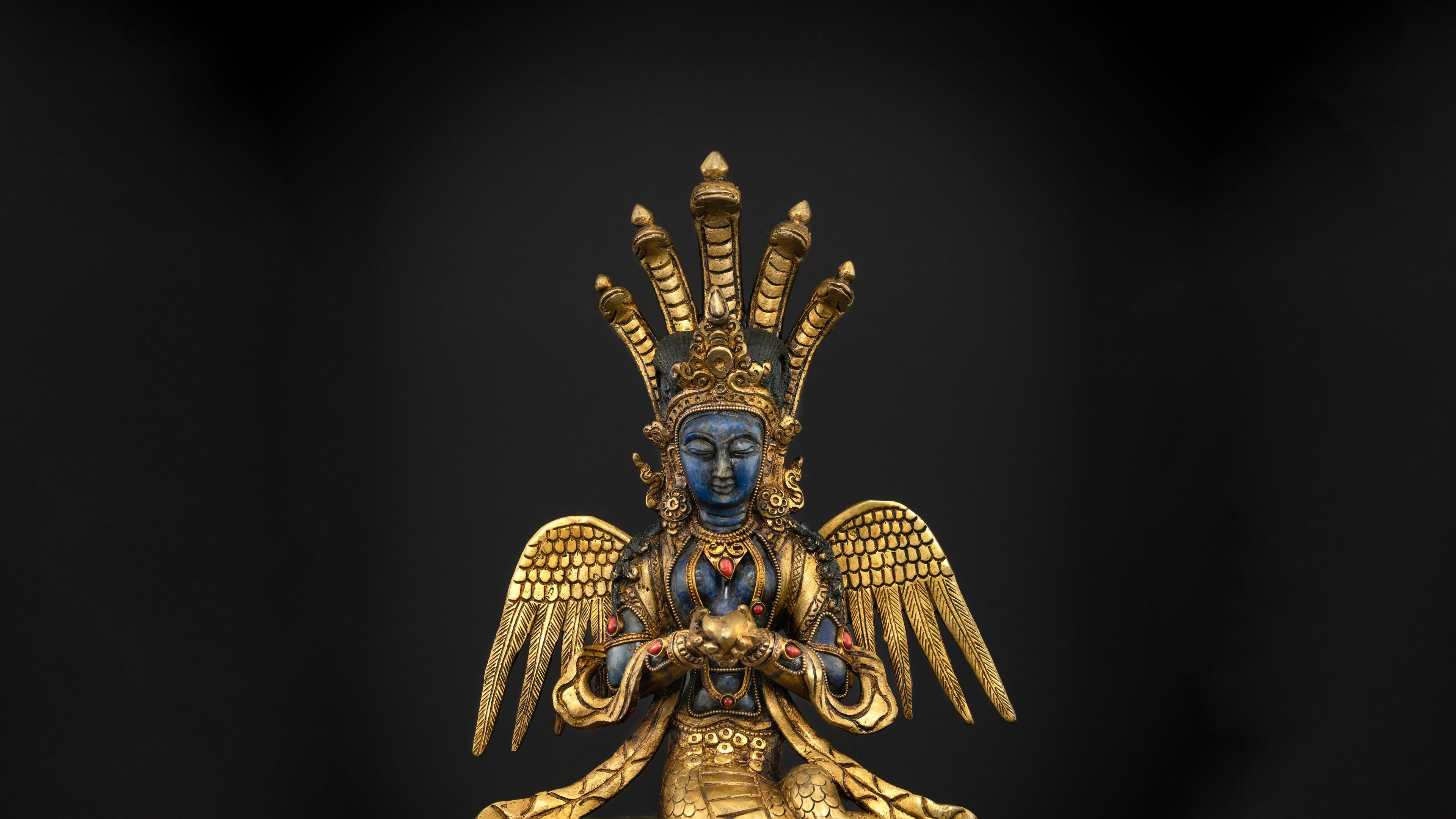 golden nagkanya statue with blue skin and having golden wings