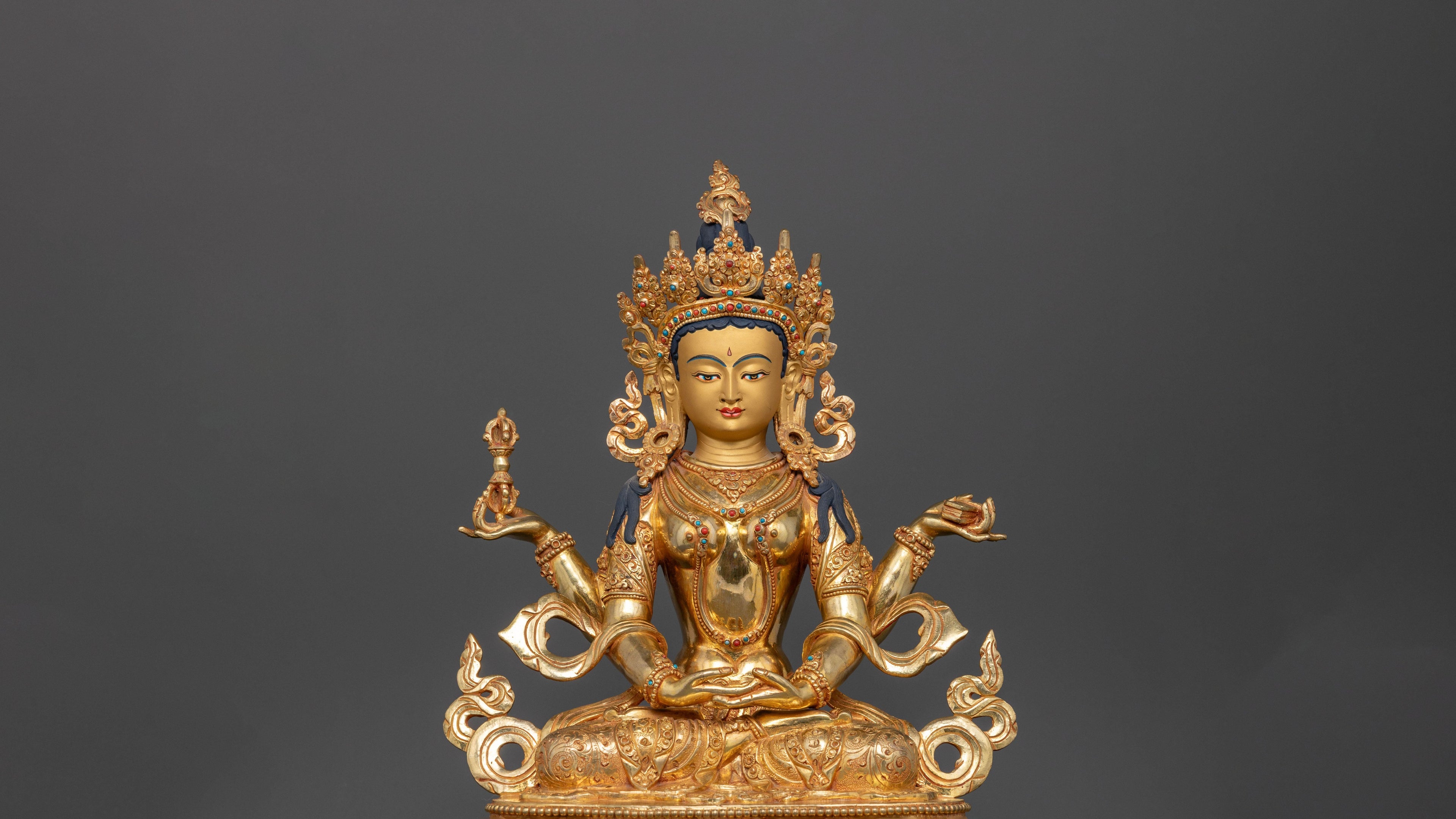 golden statue of four armed Prajnaparamita with crown sitting on a lotus seat