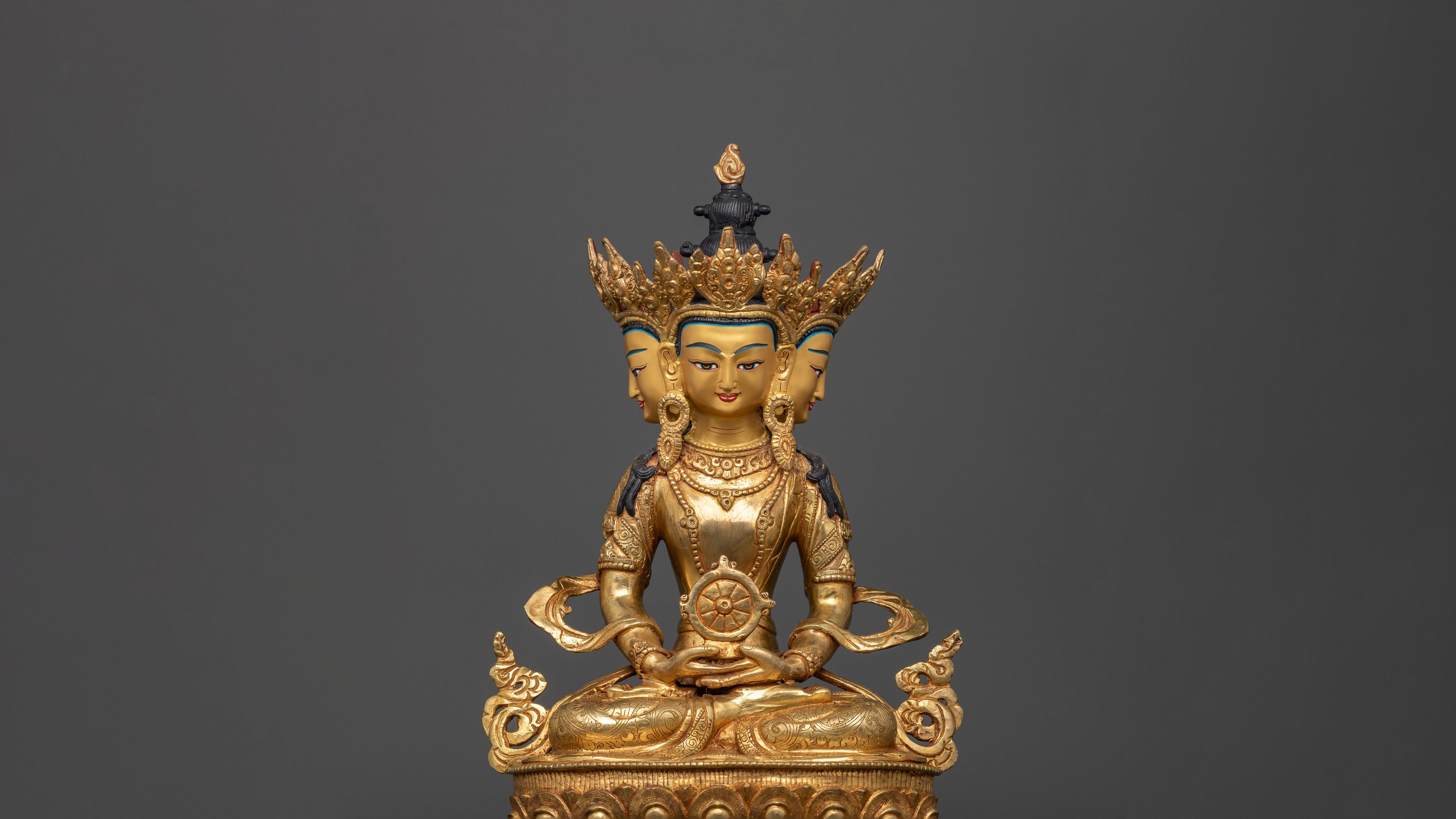 three faced gold plated Vairocana statue with intricate carvings and adorned with semi precious gemstones