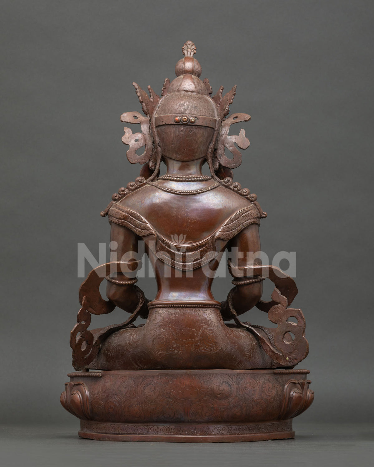 Back view Amitayus statue showing detailed robes jewelry and hand carved lotus pedestal.