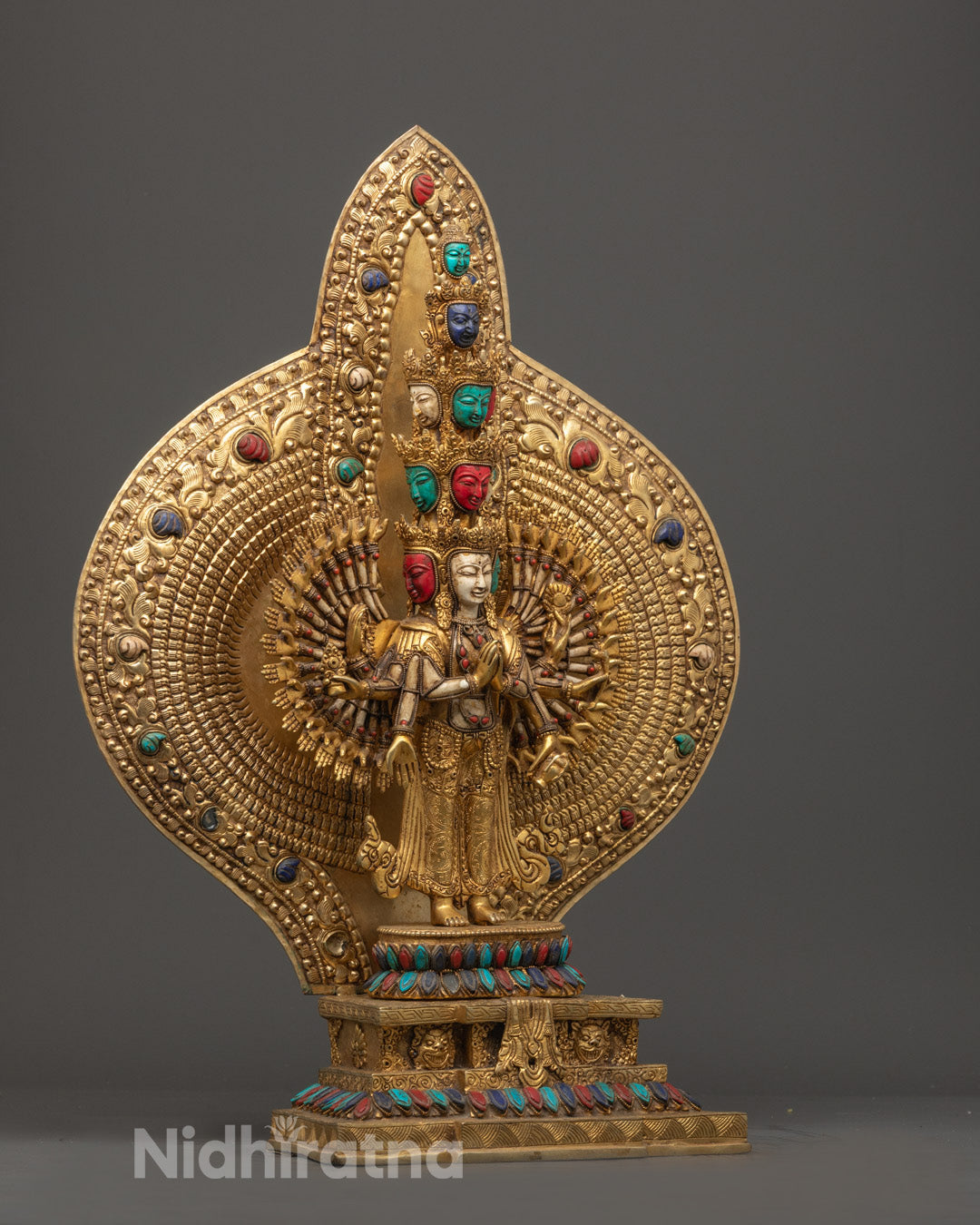 Full view of the 1000 Arm Chenrezig Statue seated on a lotus throne with a radiant halo and intricate hollow space for auspicious mantra filling.