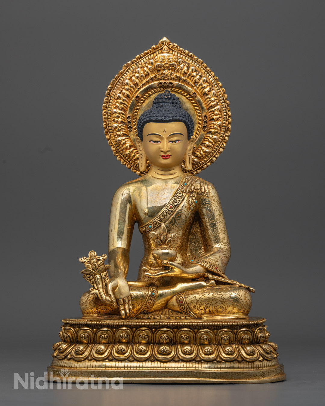 24K gold gilded Medicine Buddha statue, handcrafted from copper, depicting the Buddha seated on a lotus throne with healing nectar and myrobalan plant.