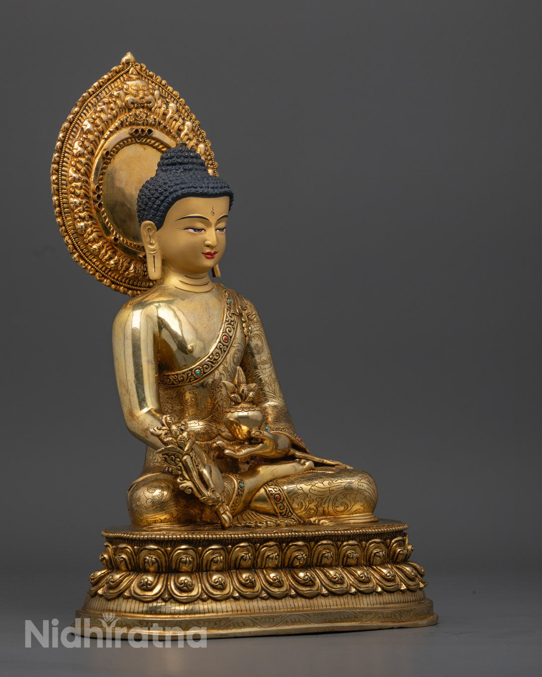  24K gold gilded Medicine Buddha statue seated in meditation on a lotus throne, symbolizing health, balance, and restoration
