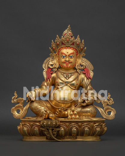 24K gold fire-gilded Yellow Dzambhala statue seated on an ornate lotus pedestal in Nepal