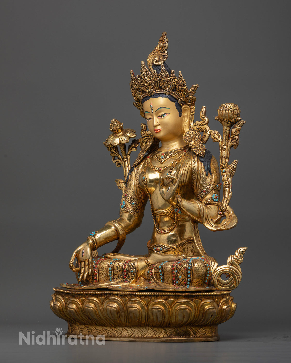 White Tara Buddhist statue with serene gold-painted face and lotus