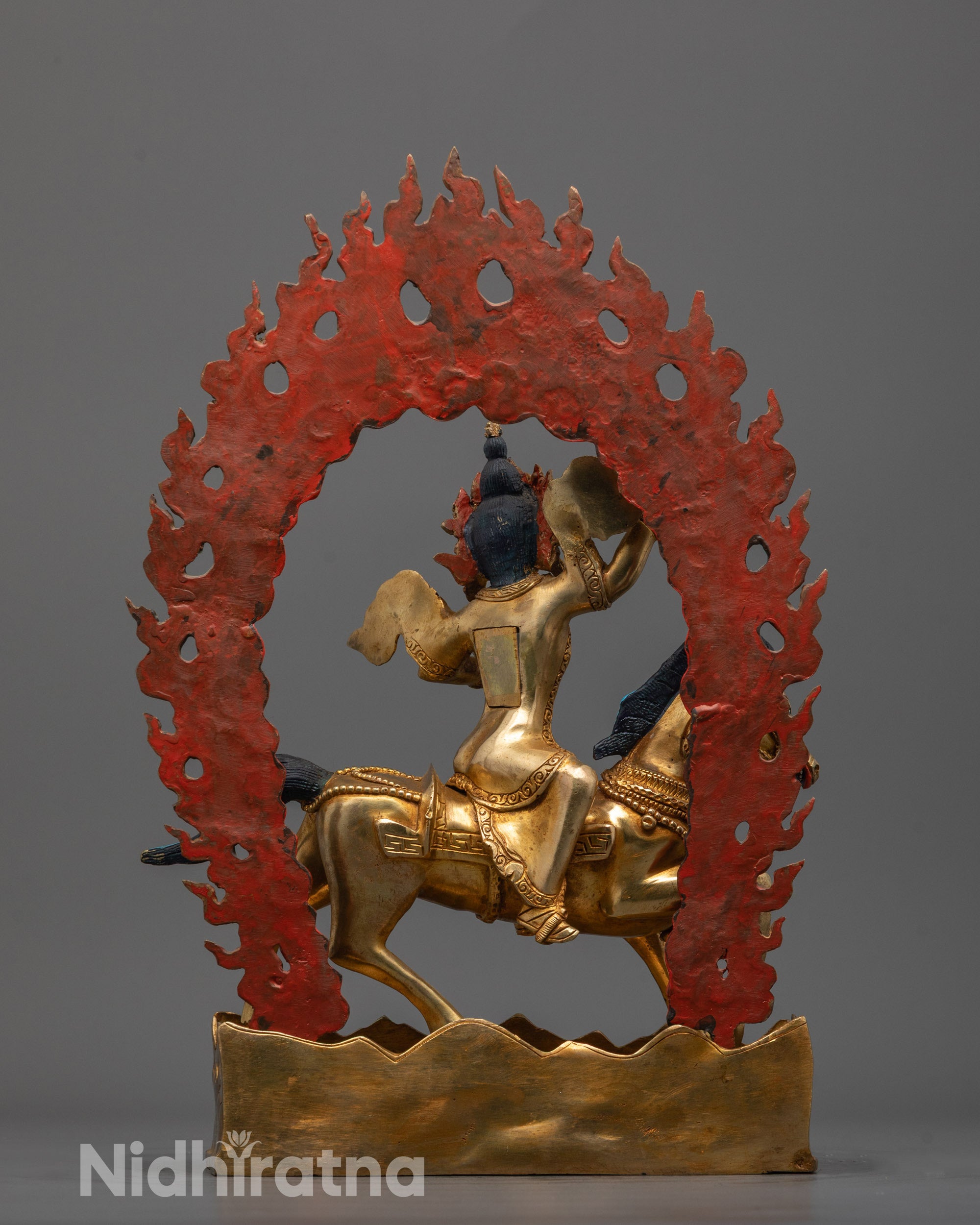 Back view of Achi Chokyi Drolma statue highlighting intricate carving on shifting landscape base
