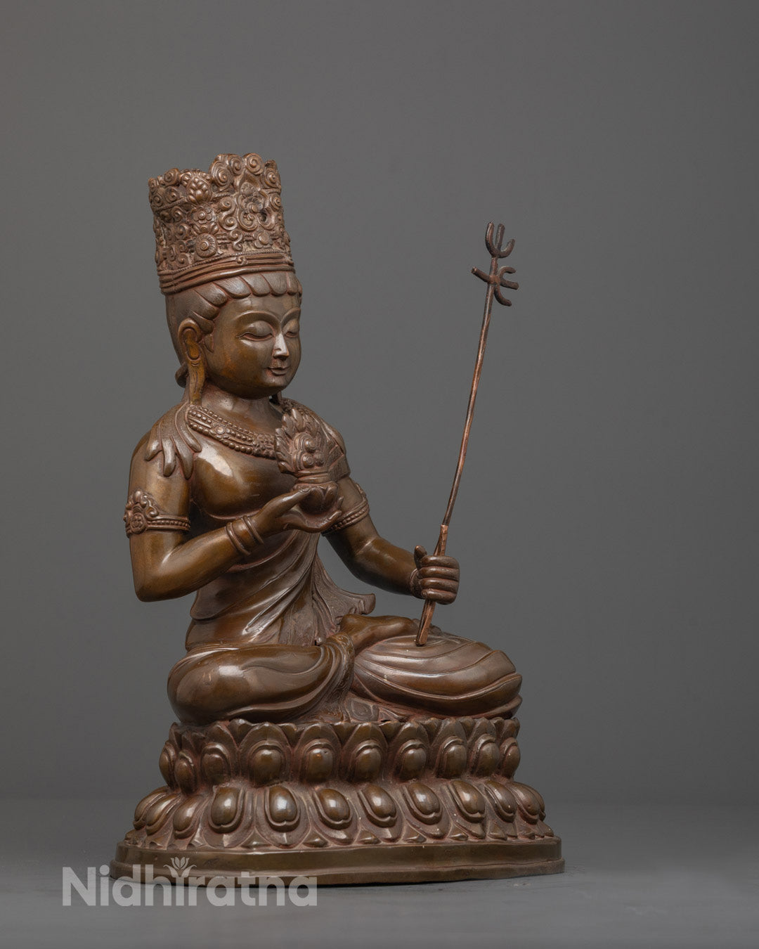 Side angle of handcrafted Akasagarbha Bodhisattva statue with gold patina and lotus base
