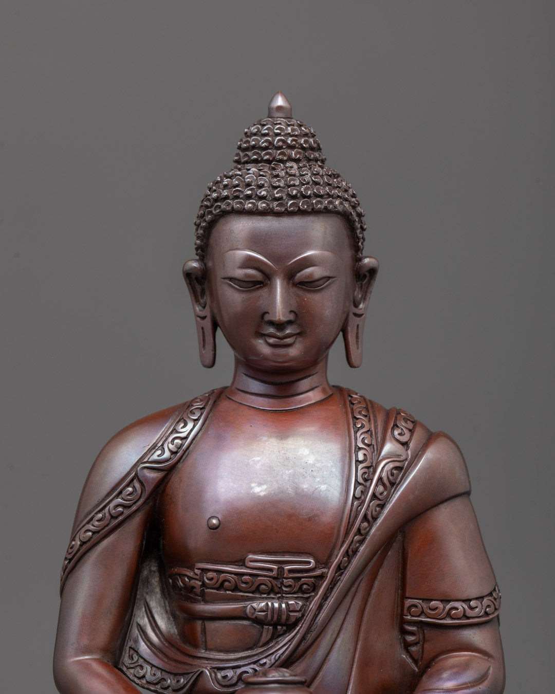Amida Buddha face close-up - serene expression, lost-wax copper craftsmanship.