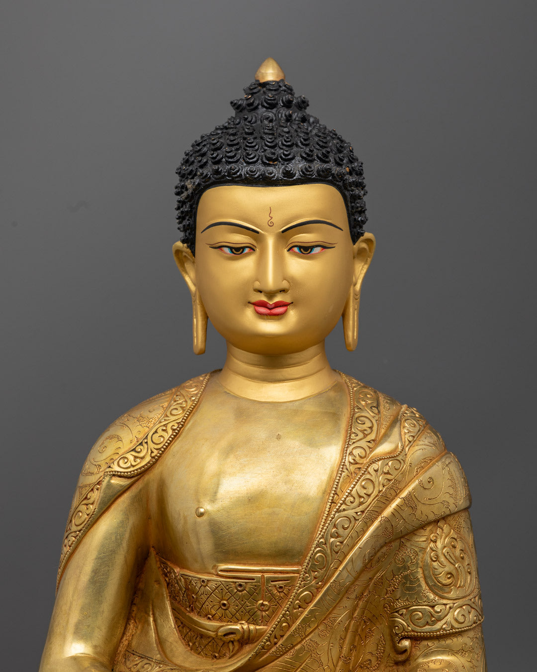 Amitabha Buddha’s tranquil face and upper body, highlighting intricate copper work and radiant gold gilding symbolizing inner peace and enlightenment