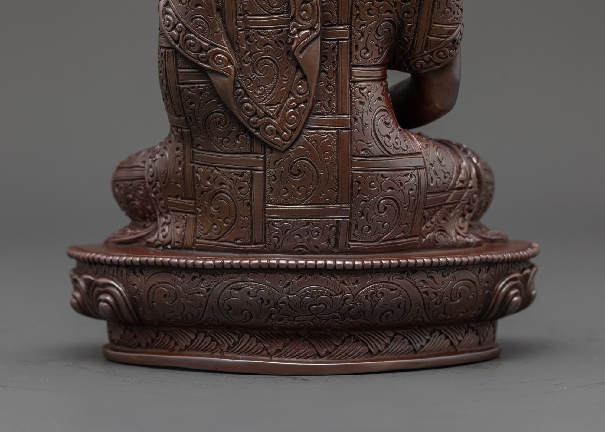 back view of oxidized three buddha set highlighting detailed copper craftsmanship and patterns
