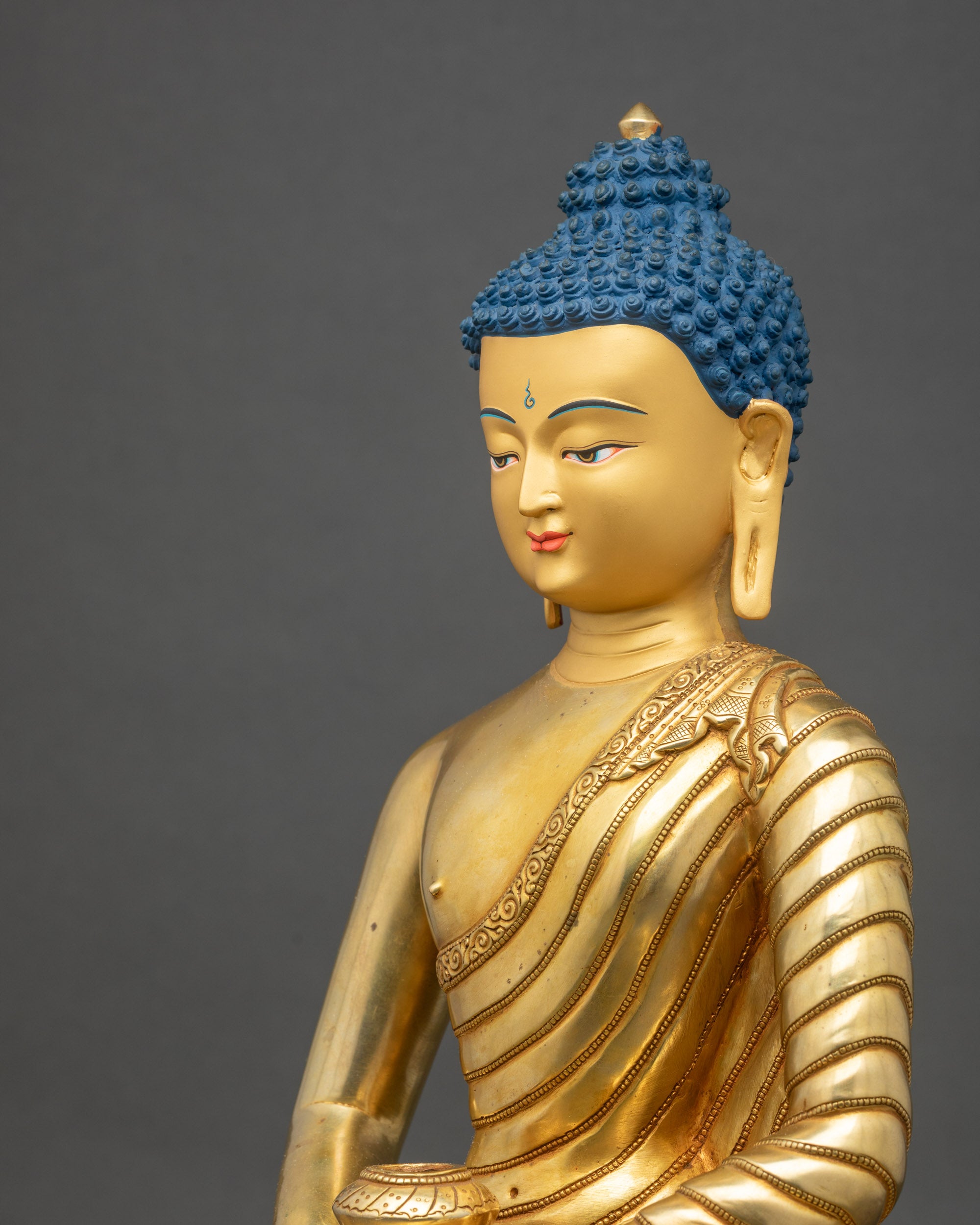 Side close-up of Amitabha Buddha statue, showing intricate lotus throne and robes