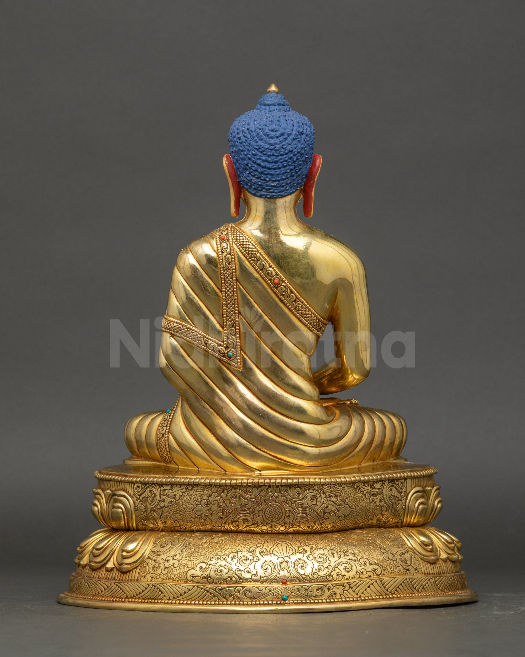 Amitabha Buddha sculpture back view showing detailed robe carvings and gold finish