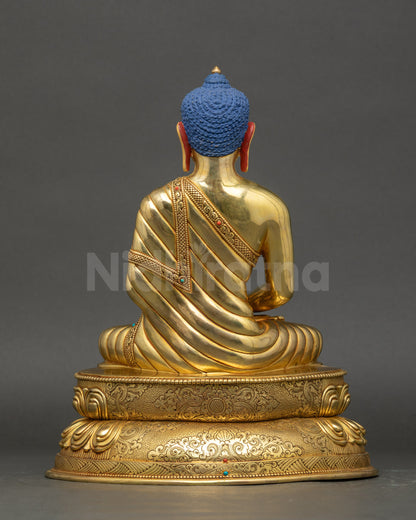 Amitabha Buddha sculpture back view showing detailed robe carvings and gold finish