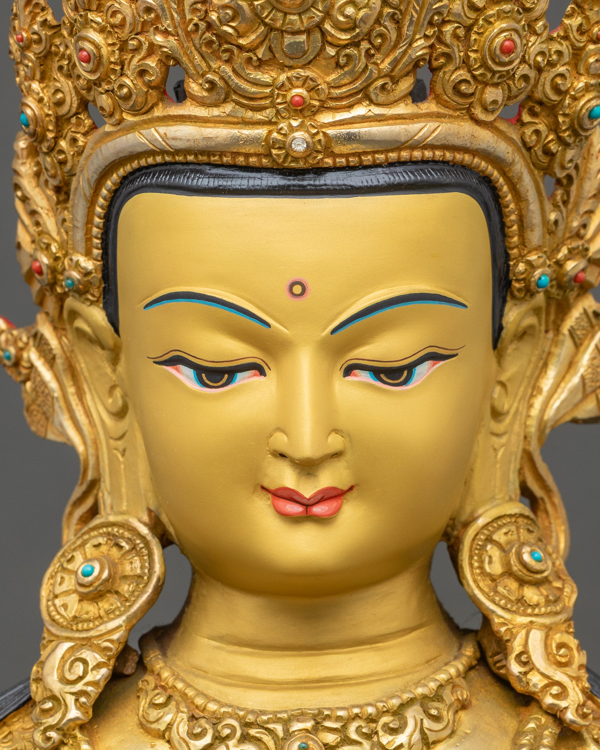 Detailed close-up of Amitayus Buddha face, serene expression, gold-painted and radiant