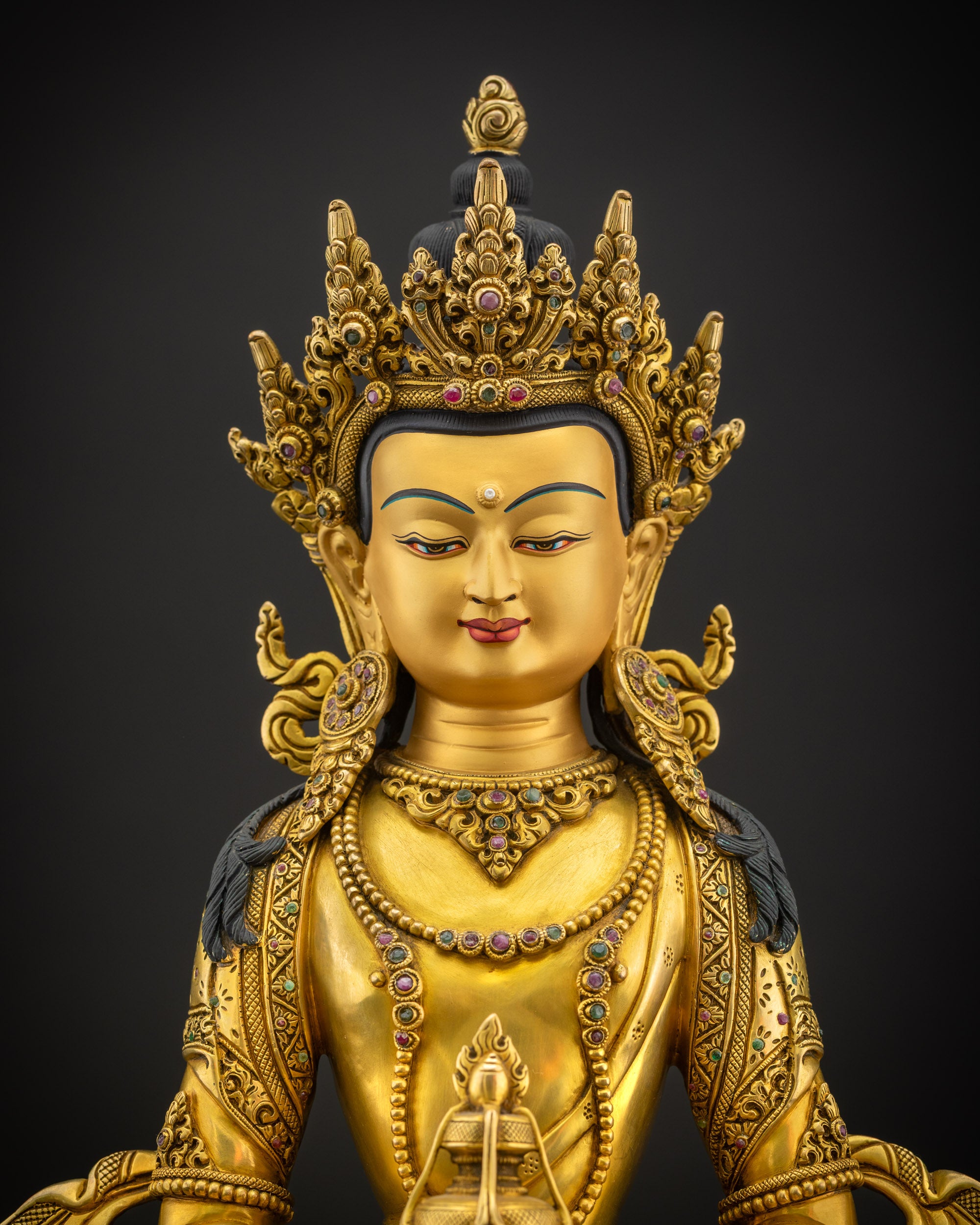 Close-up of Amitayus Masterpiece highlighting serene gold-painted face, five-jeweled diadem, and flowing hand-carved robes