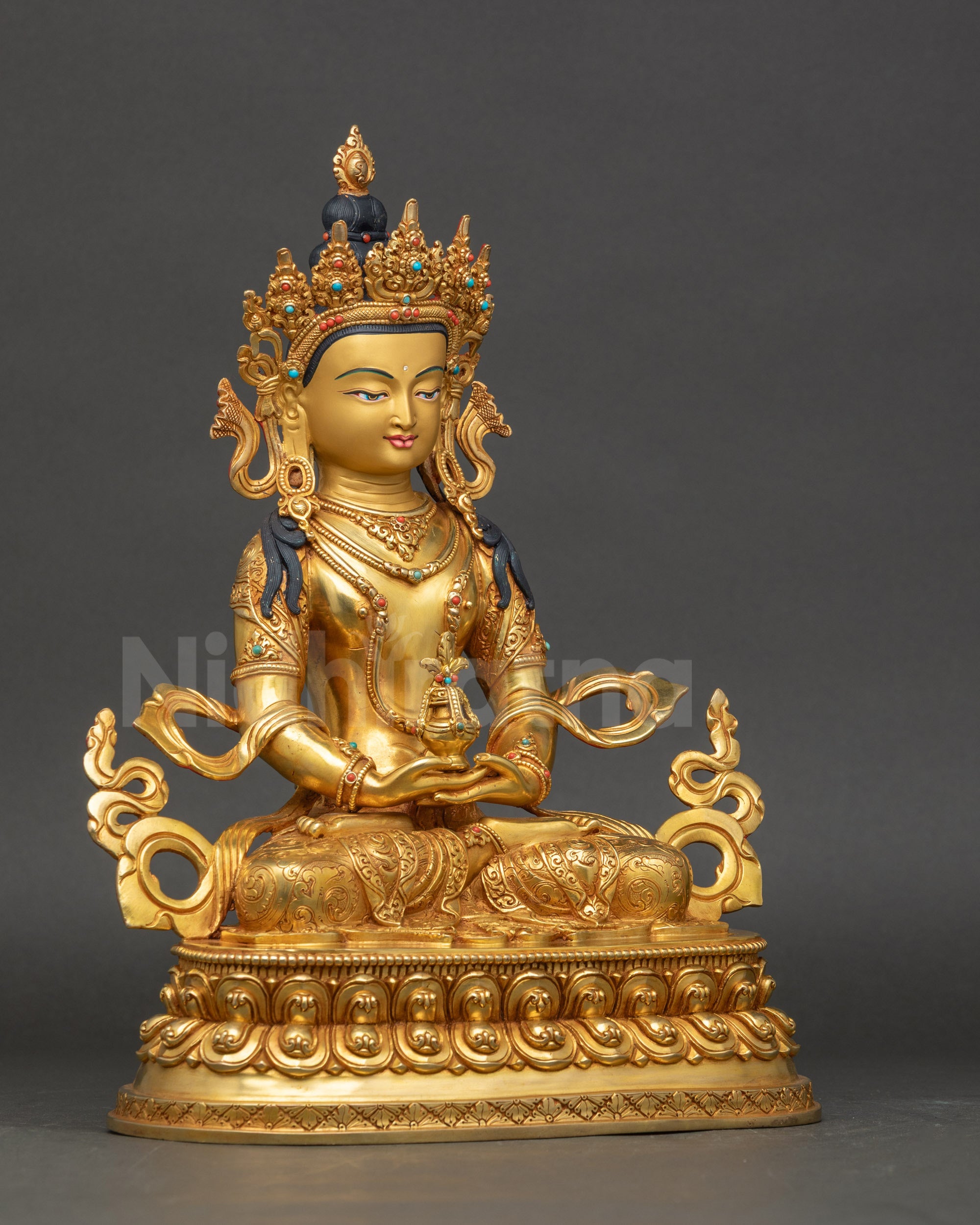 Side profile of Tibetan Amitayus statue with crown and halo