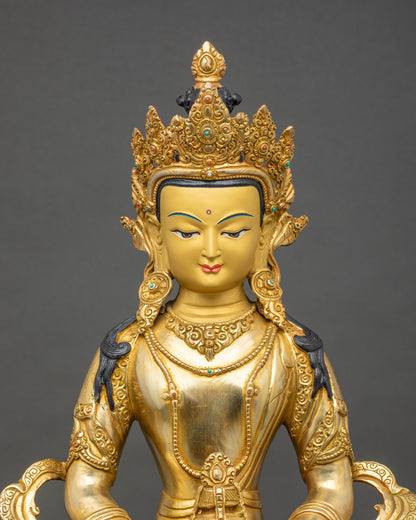 Regular close-up of Amitayus statue, polished gold layers and flowing Himalayan robes