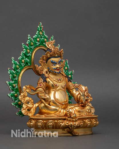 Angle showing Jambhala’s jewelry, crown, and intricate patterns on copper sculpture