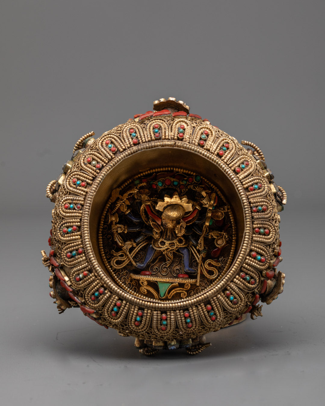 Angled base view of Tibetan rice pot showing bottom design and artisan metalwork