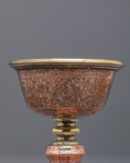 Angled close-up of Tibetan butter lamp symbolizing wisdom and spiritual clarity