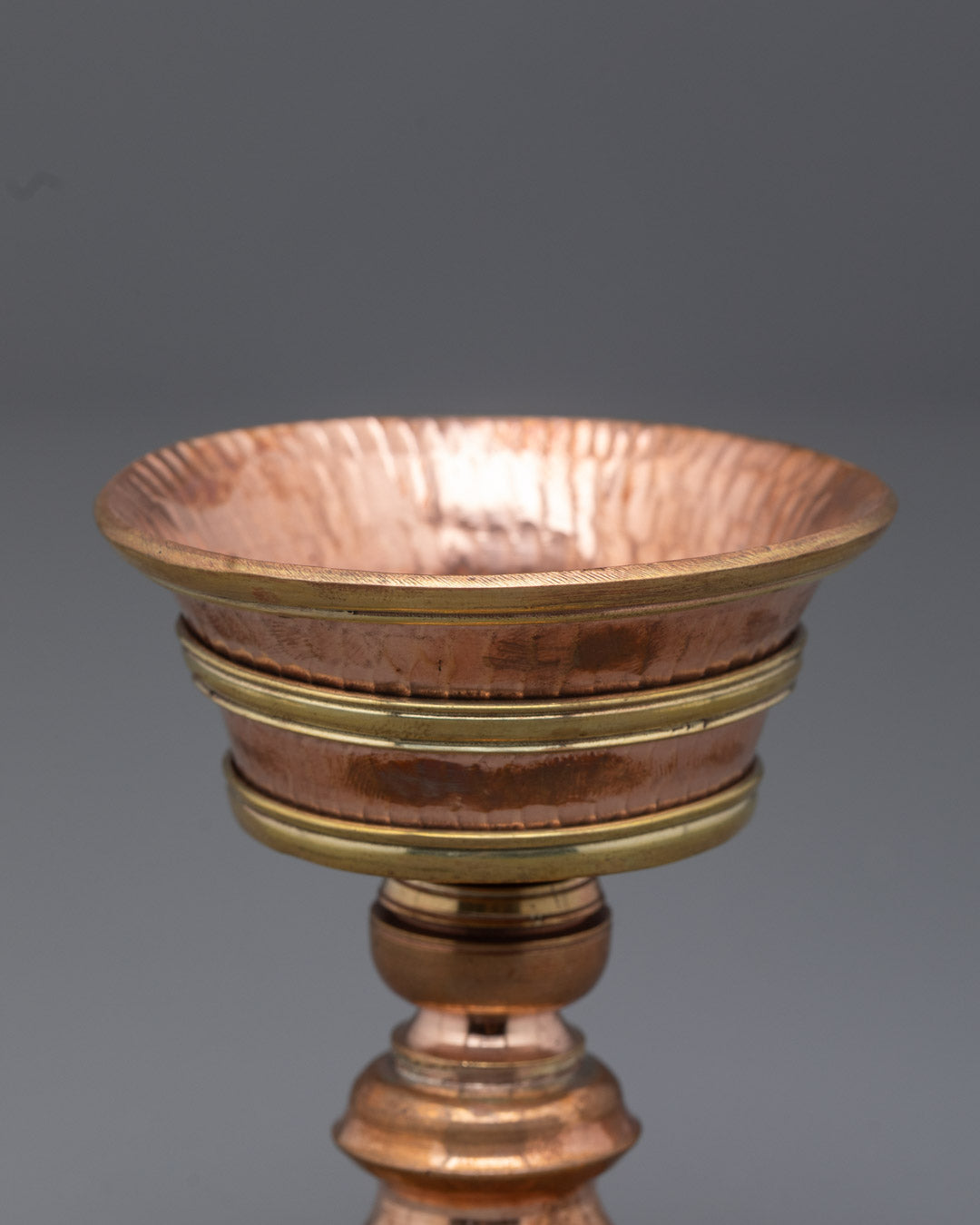 Angled close-up of spiritual butter lamp showing detailed craftsmanship