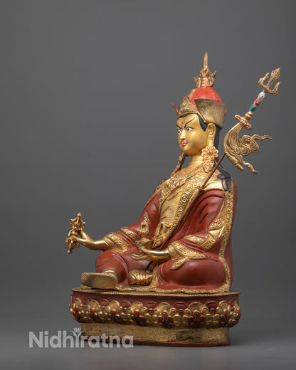 Angled shot of Guru Rinpoche holding vajra and skull cup with semi-precious stones