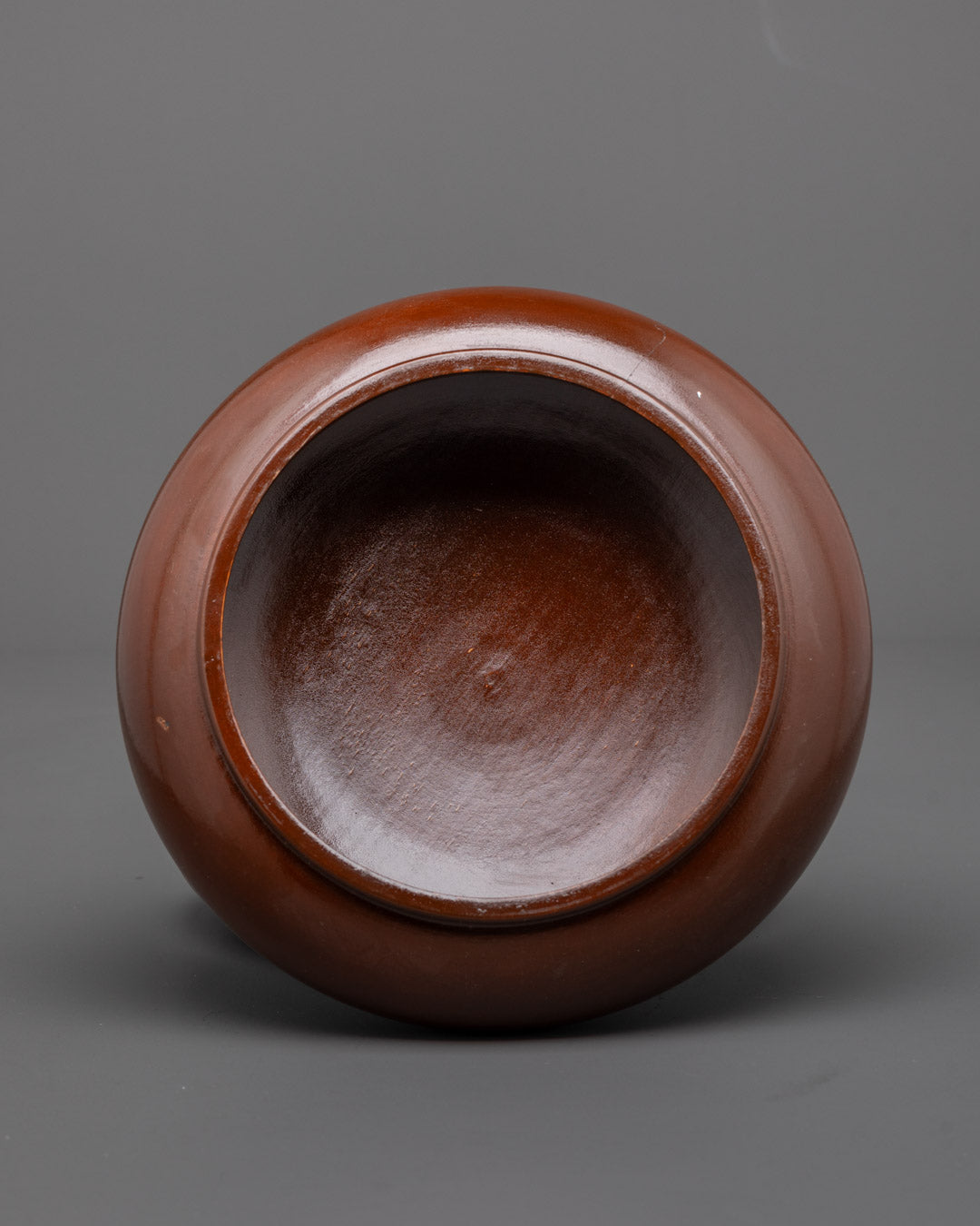 Angled side view of dark brown Paru Bowl showing smooth, shiny surface

