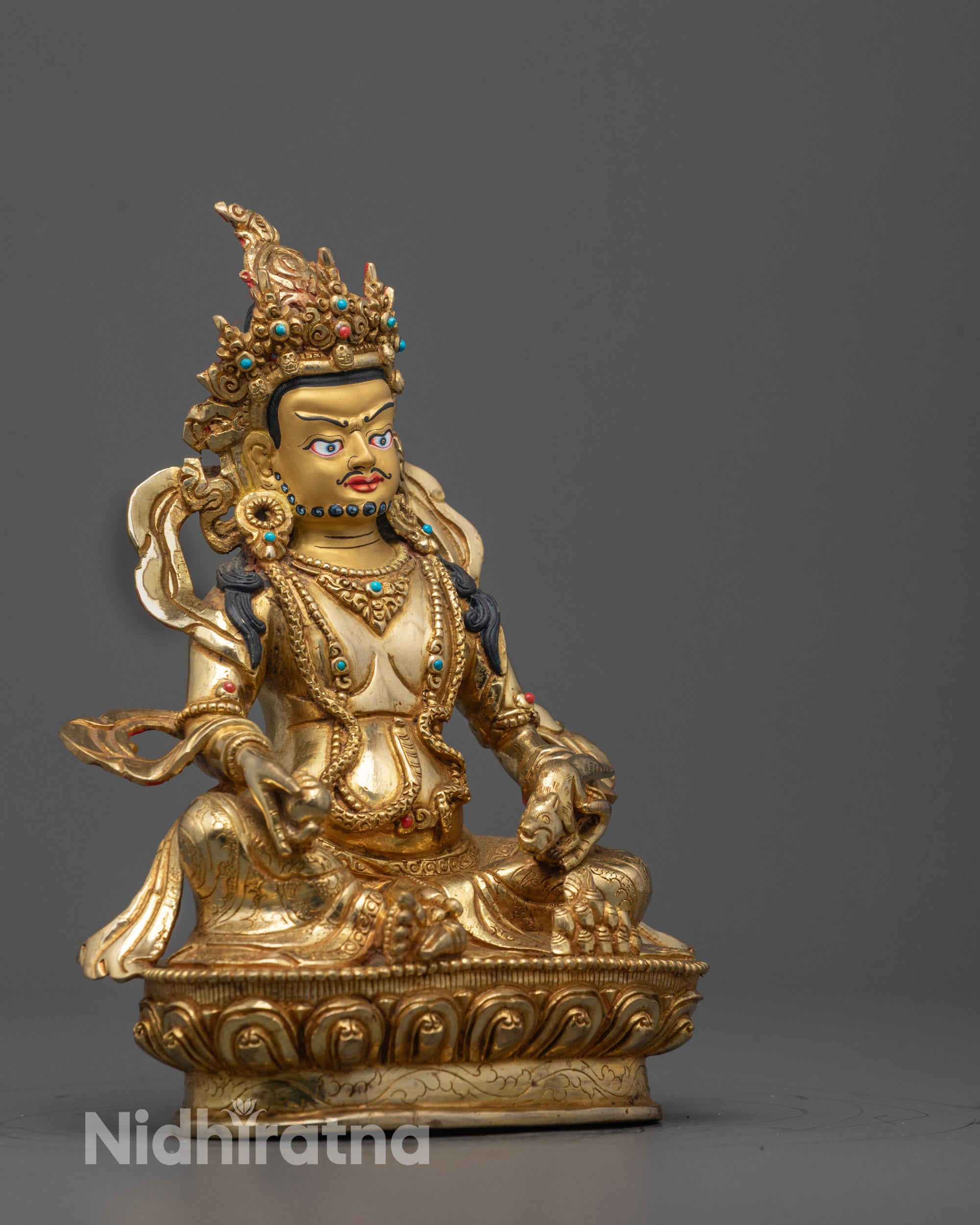 Angled side view of the Dzambhala Statue highlighting the hollow consecration chamber