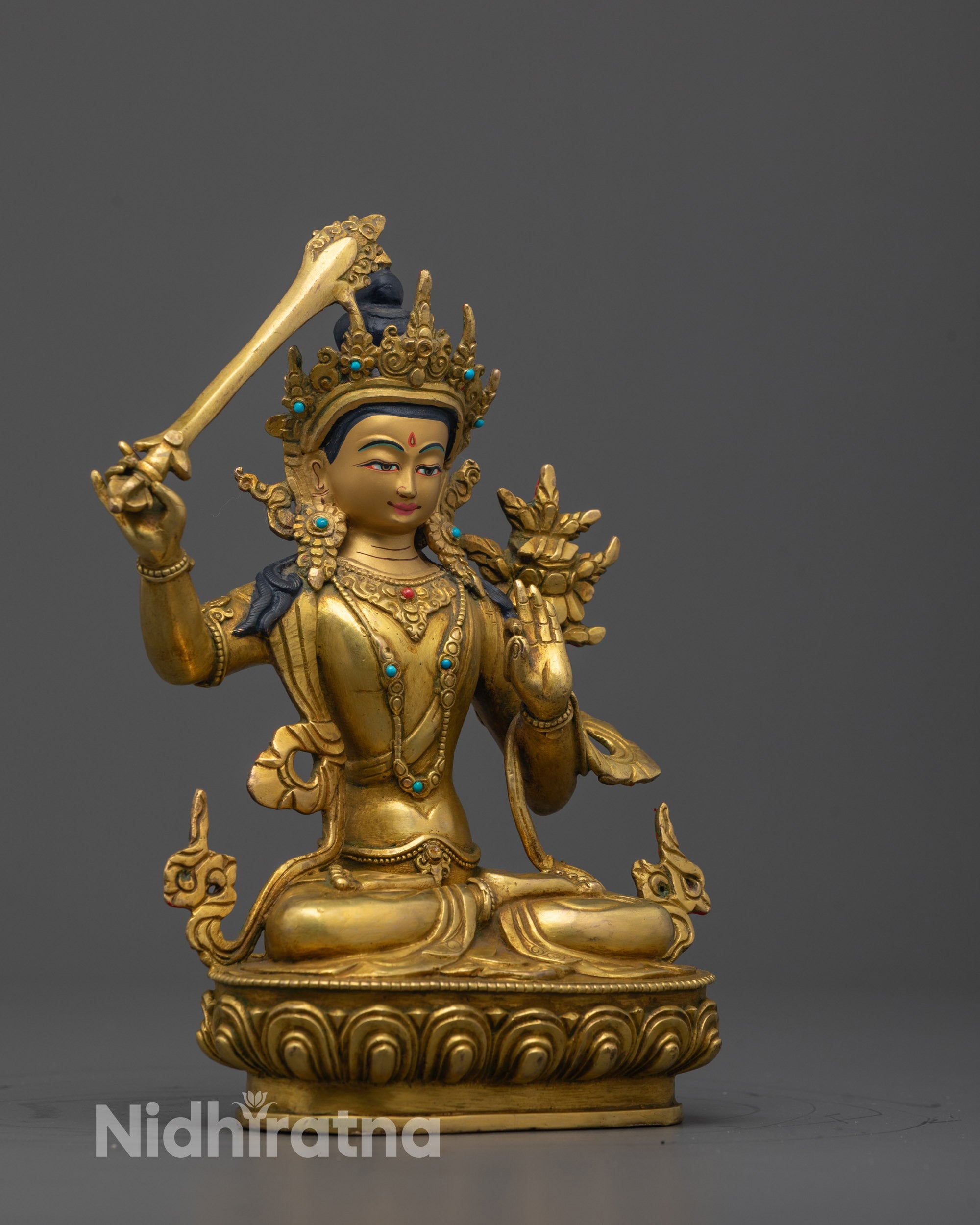 Angled side view of the Manjushri Statue revealing the elegant sword